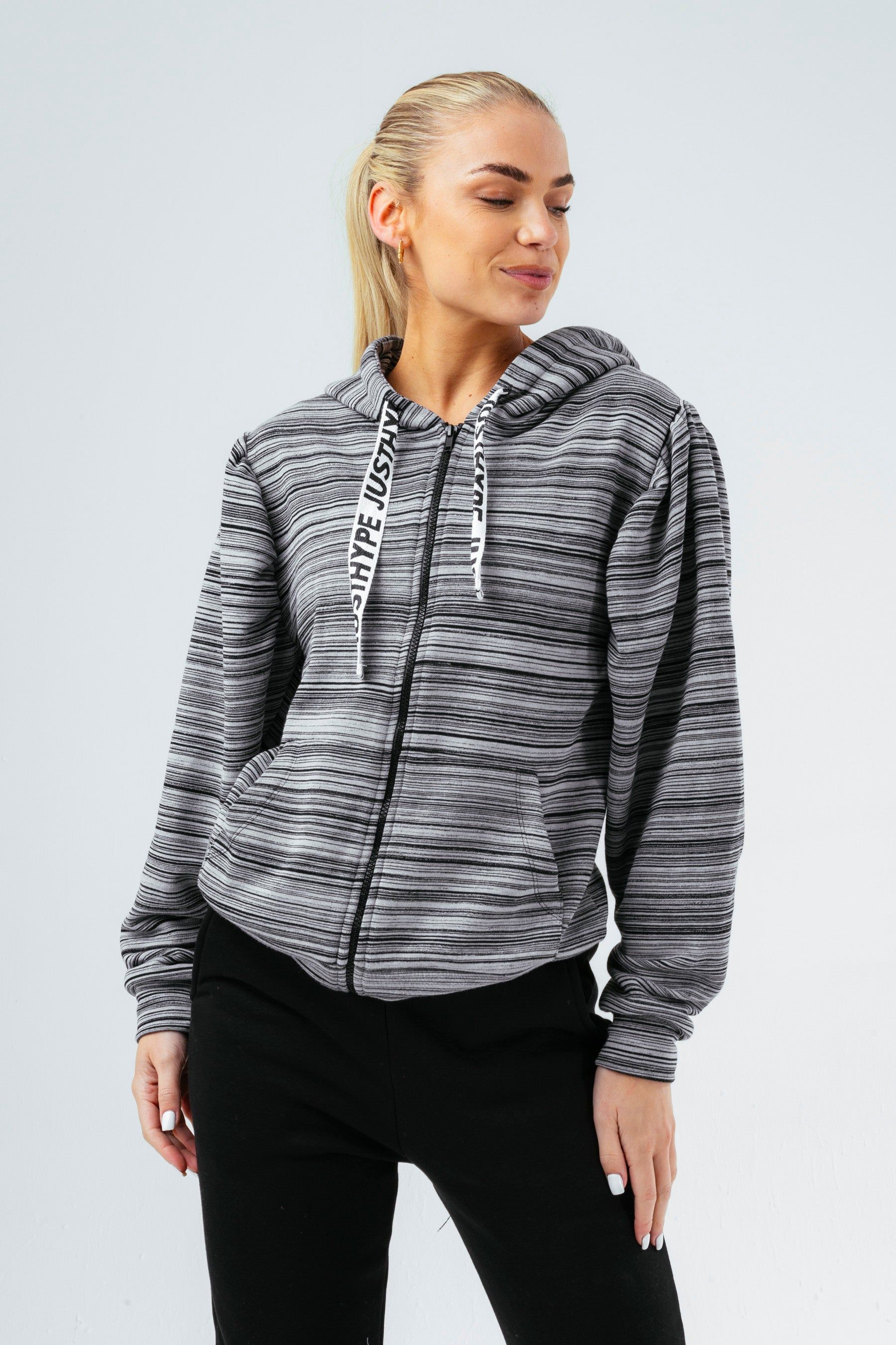 The zip hoodie staple you need every season. The HYPE. Women's Zip Hoodie. With a fixed hood, fitted cuffs, elasticaited waistband, embossed zip pullers and double pockets. Designed in a soft touch fabric base for the ultimate comfort and breathable space. If you like an oversized fit, opt for a size up, if you like a casual fit, stay true to your usual size. The model wears a size 8. Machine Washable