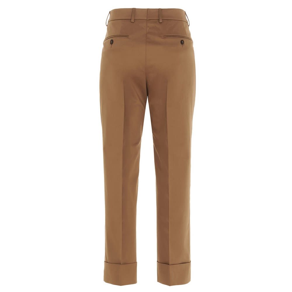 'Nevet' cotton trousers with pockets, zip, hook and button closure and turn up on the leg bottom.
