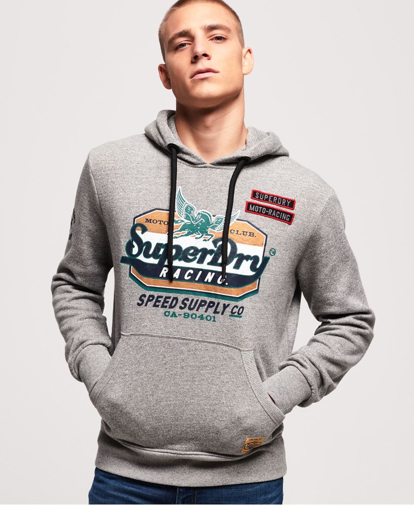 Superdry men’s Custom 1334 hoodie. Find that balance between cool and casual with the Custom 1334 hoodie. This overhead hoodie features a drawstring adjustable hood, ribbed cuffs and hem and a large Superdry logo across the chest in a cracked effect finish. The Custom 1334 hoodie is completed with embroidered Superdry logo detailing on one sleeve and a Superdry logo badge on the front pouch pocket.