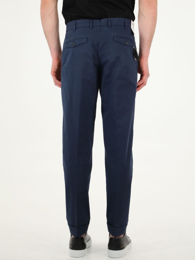 Blue cotton gabardine trousers with straight fit. They feature two side welt pockets, two rear pockets with button, rear charm and belt loops. The model is 184cm tall and wears size 48.