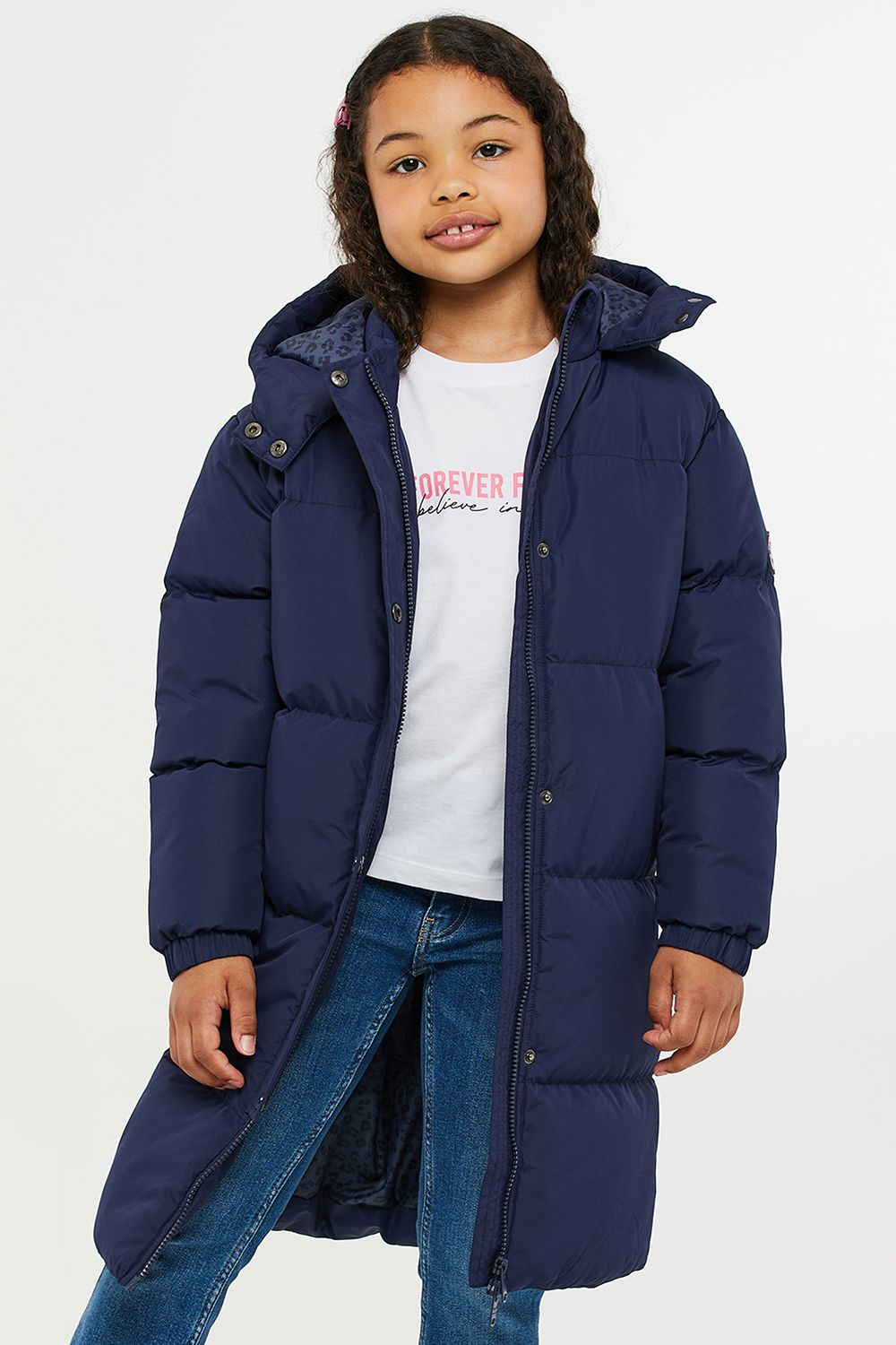 This longline hooded, padded jacket from Threadgirls features a two-way zip and popper fastenings. The jacket also has two side pockets, elasticated cuffs, and branded badge on the sleeve. Perfect for keeping warm this back-to-school season, other colours and styles are also available.