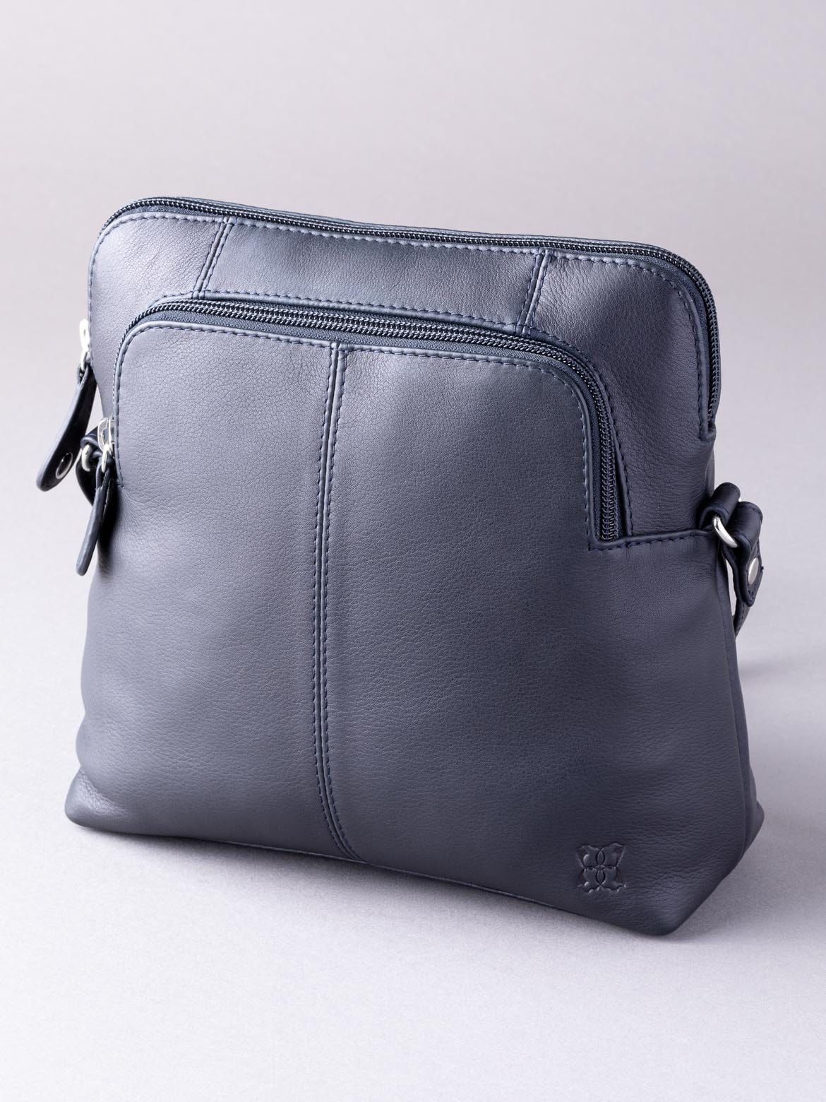 You can't argue the Raven Leather Cross Body Bag in Navy is an all-weather, all-season cross body bag. Substitute your usual handbag for this charming and functional new season update, the Raven Cross Body in Navy. Crafted using real soft quality leather, the Rachel is complete with silver tonal hardware and an adjustable strap for easy wear and styling. A versatile bag that is ideal for everyone and every day use.