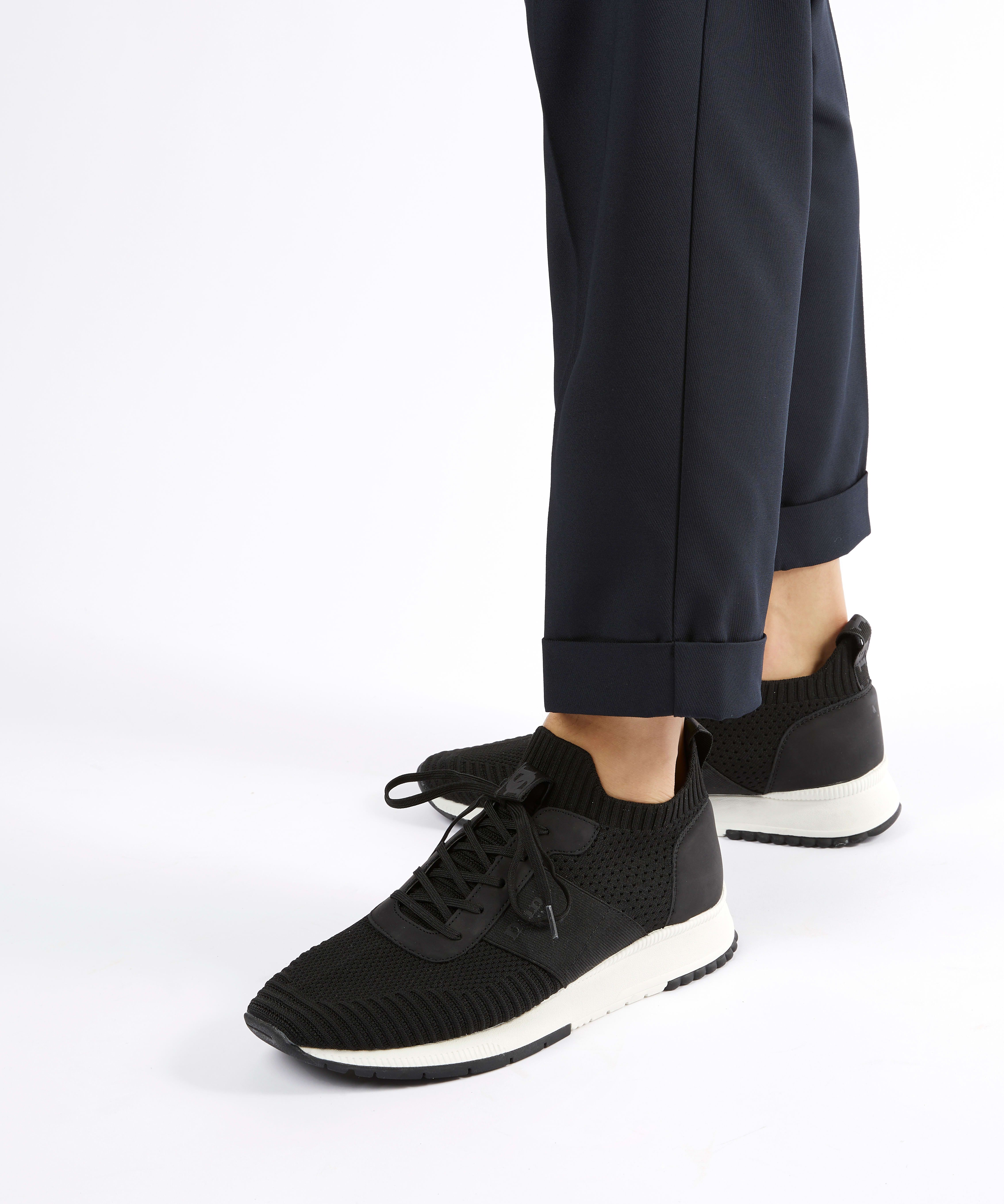 These trainers combine on-trend knitted detailing with a sporty profile. This breathable, lightweight style is available in an array of neutral colourways and features a wedge sole.