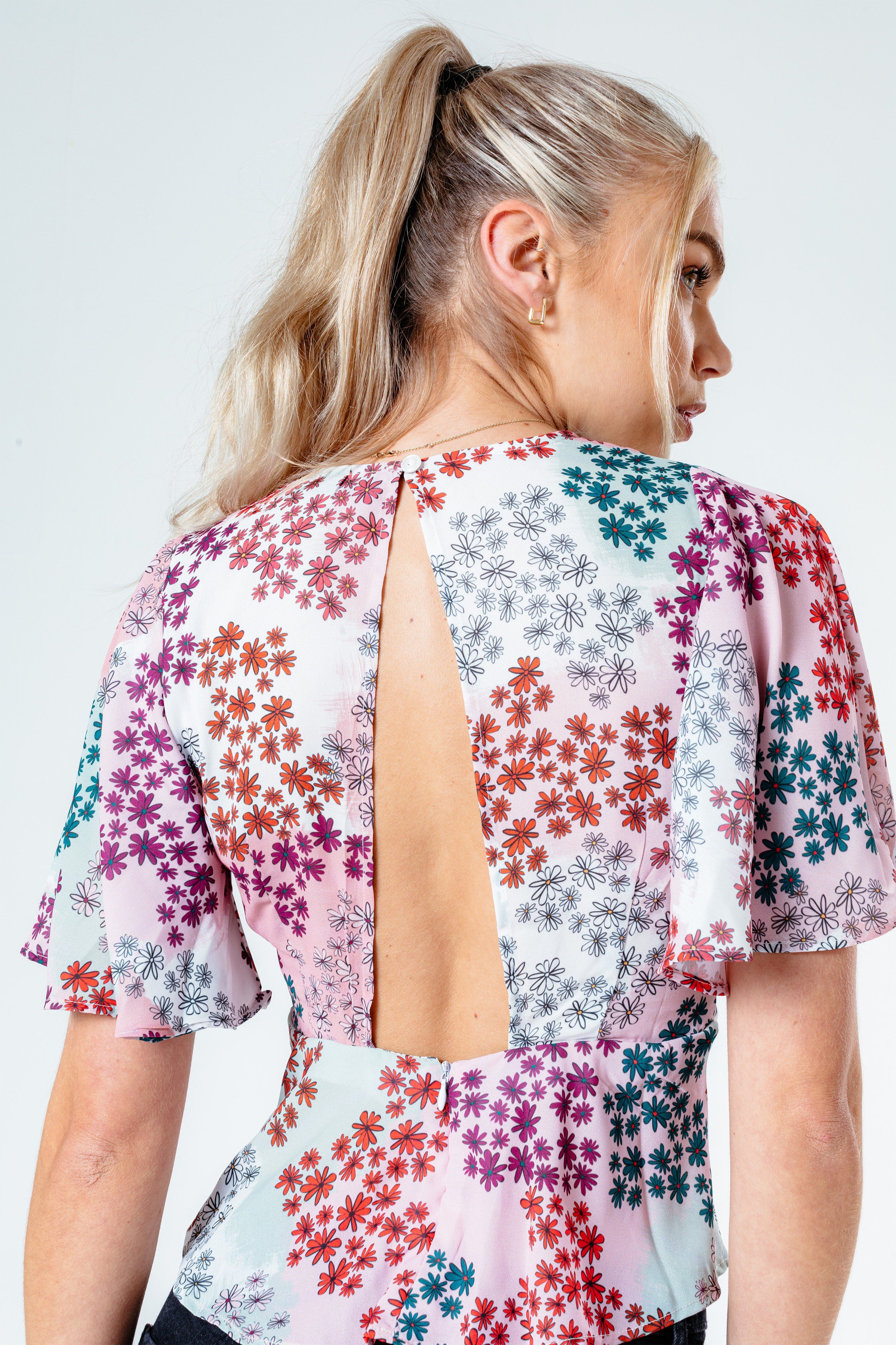 The HYPE. women's paint daisy blouse features a dusty pink, mint, purple and red colour palette. Designed in an all over floral inspired design in a poly fabric base for comfort and breathable space. In our standard women's eve blouse t-shirt shape and  short sleeves. Wear with high-waisted denim jeans for an everyday essential look. Machine washable.