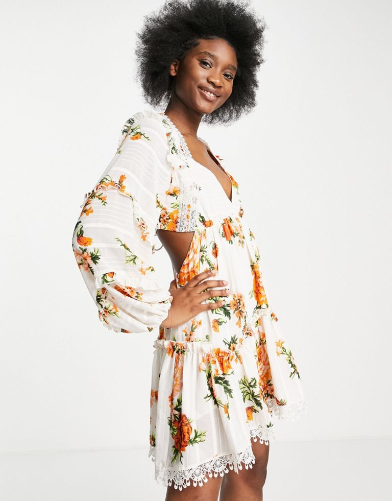 Mini dress by ASOS DESIGN Big floral energy Tiered design Plunge neck Volume sleeves Open back with tie fastening Contrast trims Regular fit Sold by Asos