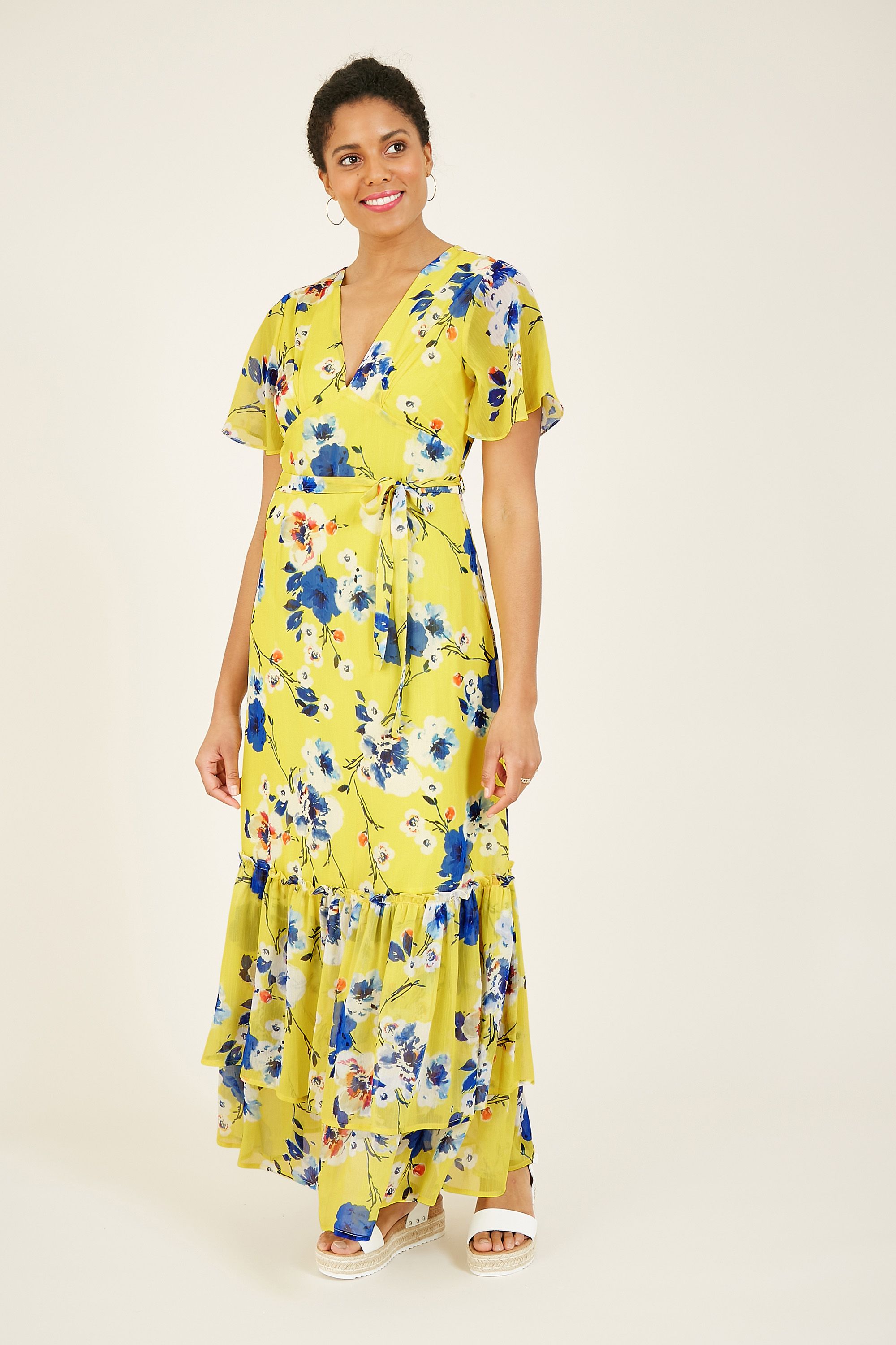 A truly versatile, lightweight piece, our Yumi Yellow Floral Maxi Dress brings a cheerful dash of colour to any wardrobe and can be easily styled up or down. Featuring a self tie waist belt, classic boxy sleeves and a cute peep button fastening. The result? A timeless, ultra-flattering fit. Pair with strappy heels and a matching clutch, or for an edgier, year-round look, think chunky boots, statement earrings and a knitted cardigan.  100% Polyester Machine Wash At 30 Length is 138.5CM