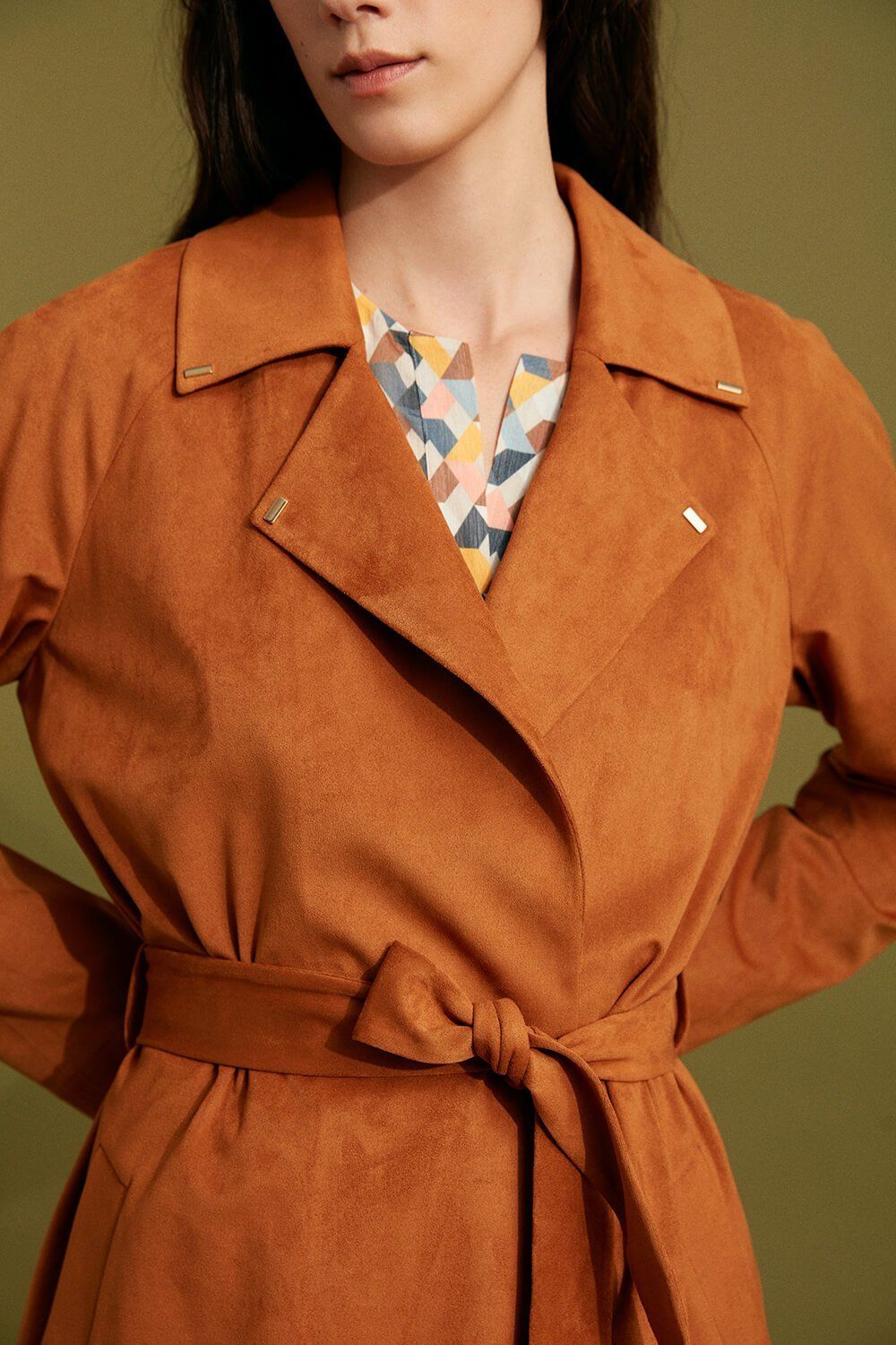 Through its flowy fabric and soft texture, this take on the classic trench coat is perfect for seasonal transitions. This terracotta, trench style coat is defined by a clean-cut silhouette, narrow shoulders, and a wrap close belt. The refined silhouette can be worn belted for a fitted look combined with your favourite dress and heels or simply with sneakers and jeans for a more casual daytime look.

Mid-calf length
Long sleeves
Wrap close belt
Terracotta colour
Model is 5'10