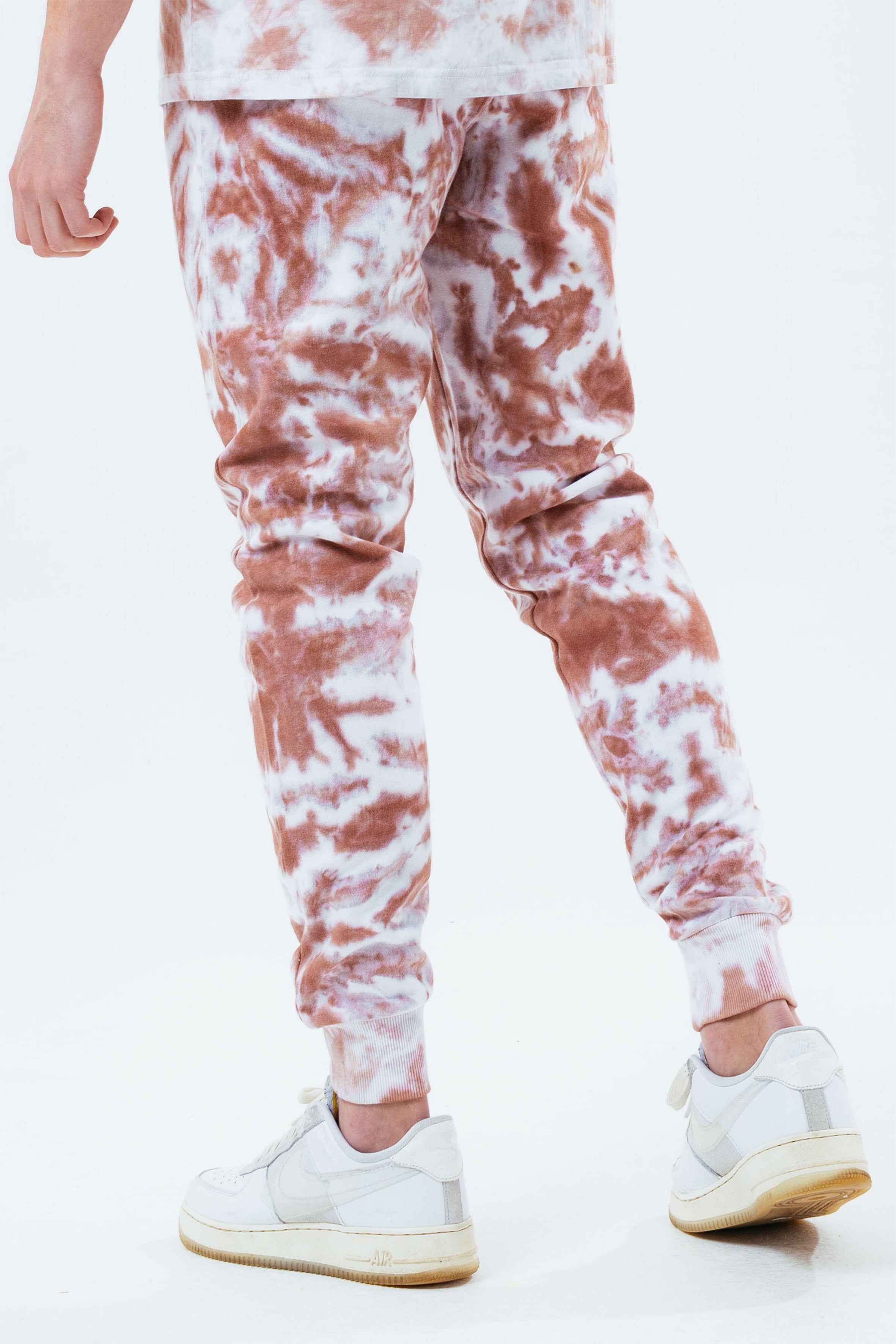 Stay on trend with the Hype Beige Tie Dye Scribble Logo Men's Joggers and grab the matching hoodie to complete the set. Designed in a soft-touch 70% Cotton 30% Polyester fabric base with the supreme amount of comfort you need from your new joggers. The design boasts an acid wash or tie-dye wash finish with an elasticated waistband, drawstring pullers and fitted cuffs. Machine wash at 30 degrees.