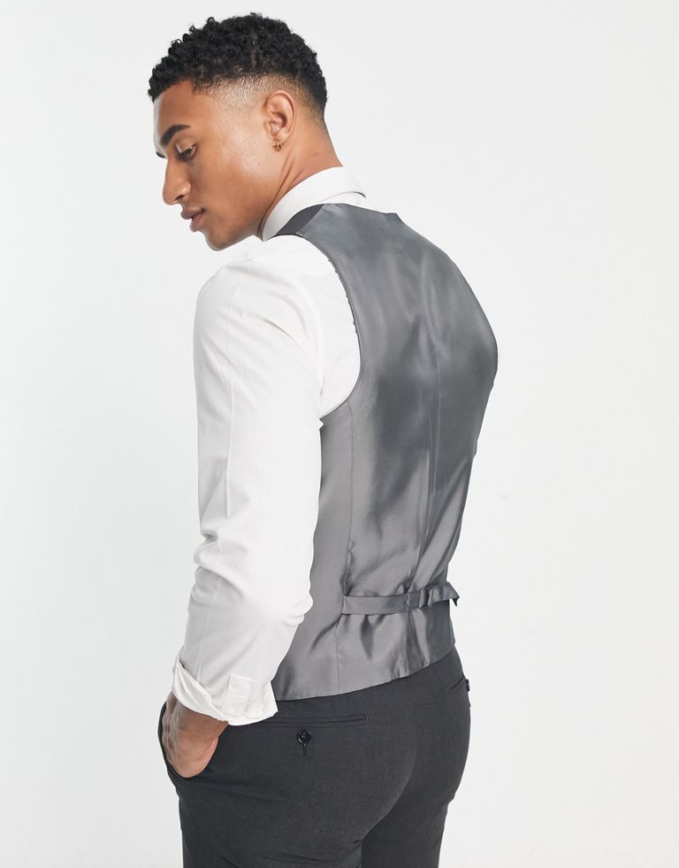 Suits by Noak For office, or out of office V-neck Button placket Contrast back with an adjustable cinch Slim fit Sold by Asos