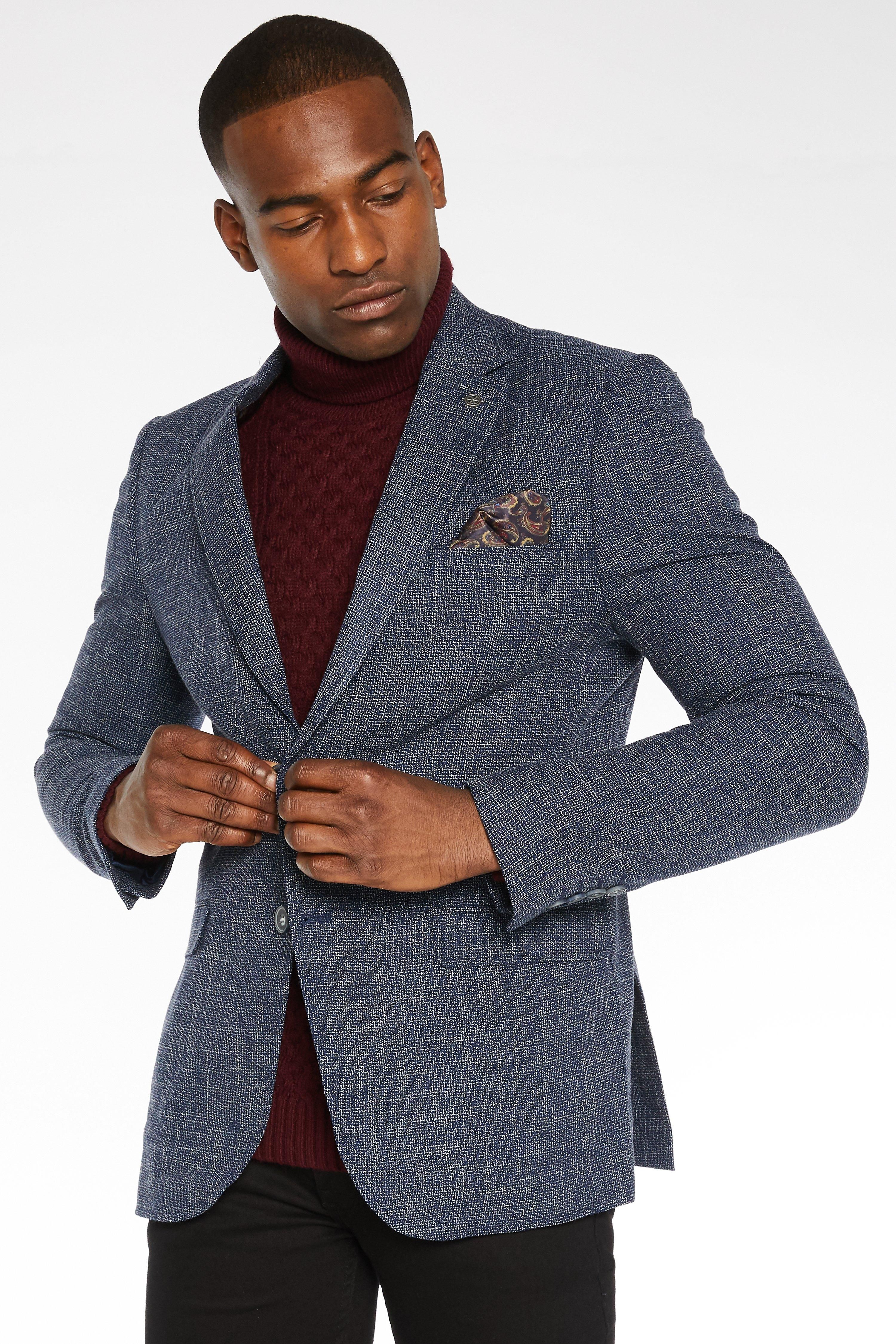 - Fleck Design  - Lined with Internal Pockets and Pocket Square  - Peaked Lapel  - Double Vented Back  - Fuctional Pockets