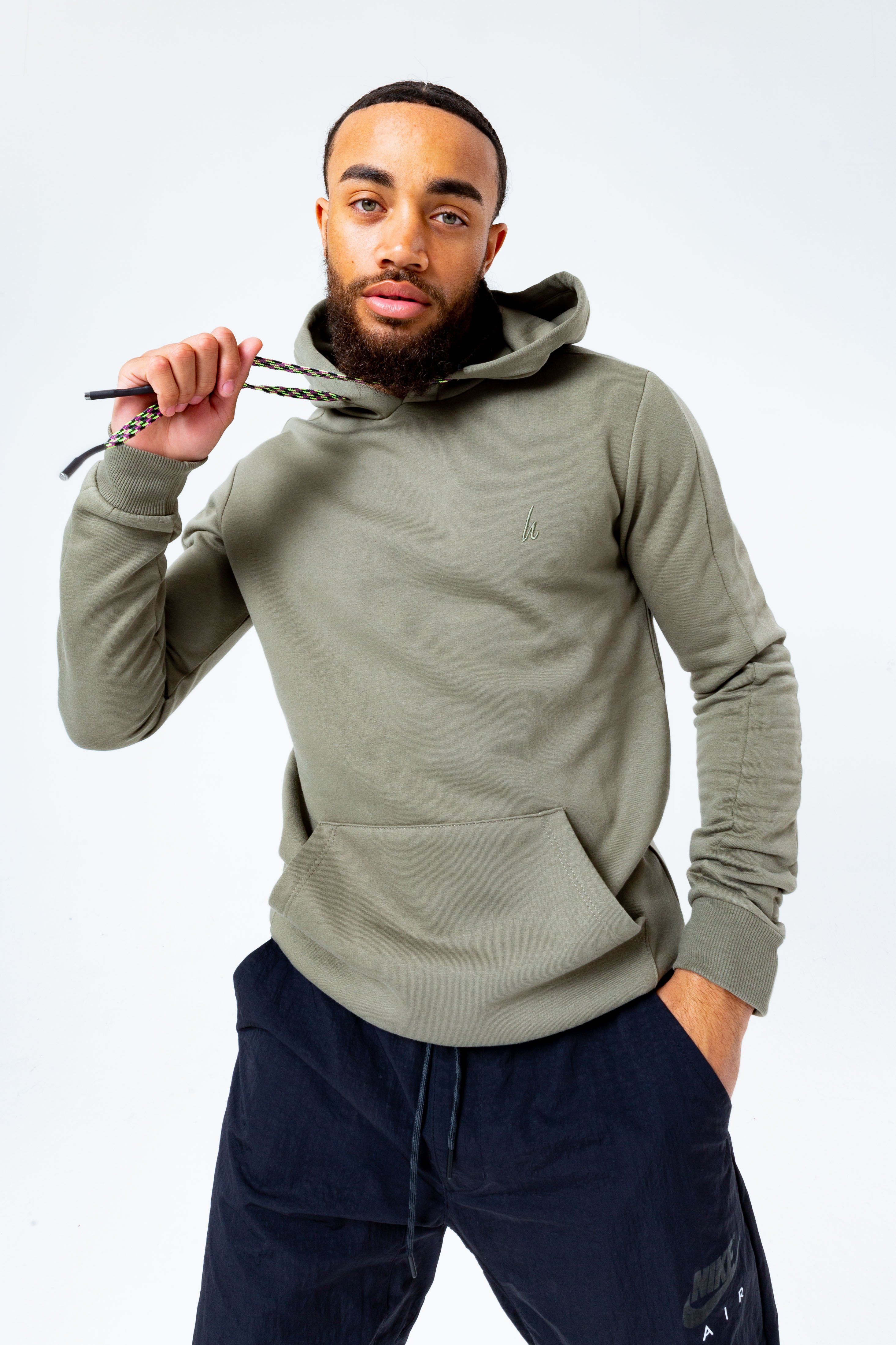 The HYPE. Olive Oversized Men's Pullover Hoodie is your new go-to everyday essential. Designed in our oversized men's hoodie shape, with a fixed hood, kangaroo pocket and fitted hem and cuffs. With a 80% cotton and 20% polyester fabric base for supreme comfort and breathable space. With a olive khaki colour palette, self fabric piping and extra long on-trend paracord strings. Finished with the new! embroidered just hype signature logo embroidered on the front. Wear with black skinny fit jeans for a smart casual look. Machine washable.