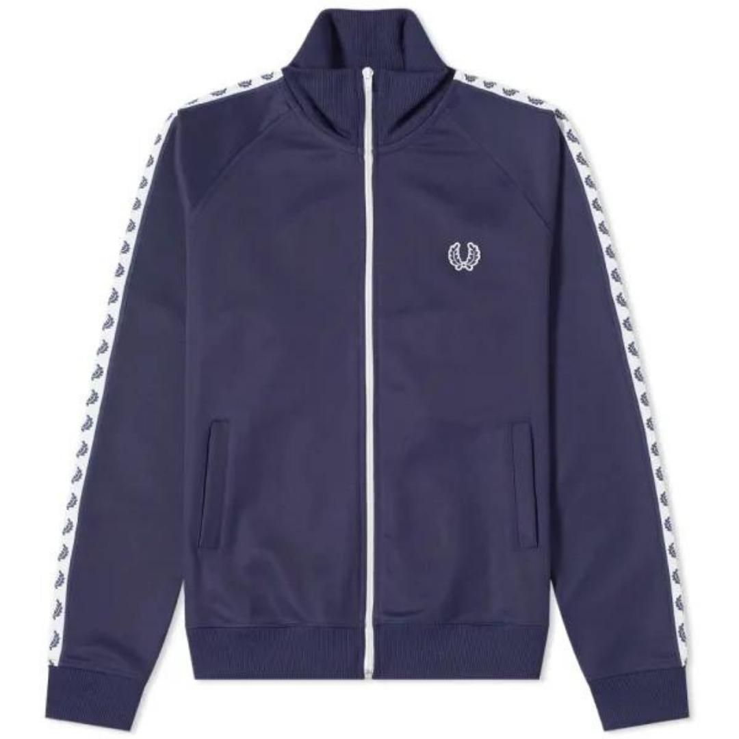 Fred Perry J6231 584 Navy Blue Taped Track Jacket. Fred Perry Blue Zip Up Jumper. 54% Polyester 46% Cotton. Regular Fit. Style: J6231 584. Branding Along Sleeves