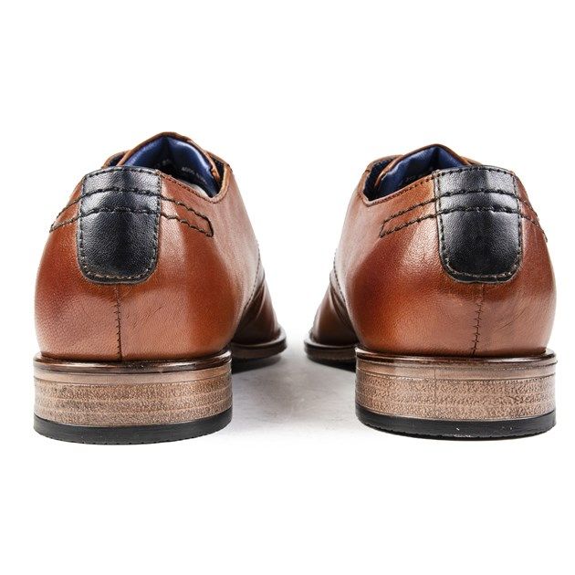 A Debonair Style And Timeless Design, The Tan Bugatti Gibson Lace-up Derby Shoe Is A Must-have For The Modern Gentleman. Featuring A Luxurious Leather Upper With The Designer's Signature Metall Stud, Detailed Heel, Waxed Contrast Laces, And Cushioned Innersole, These Shoes Are Effortlessly Elegant.