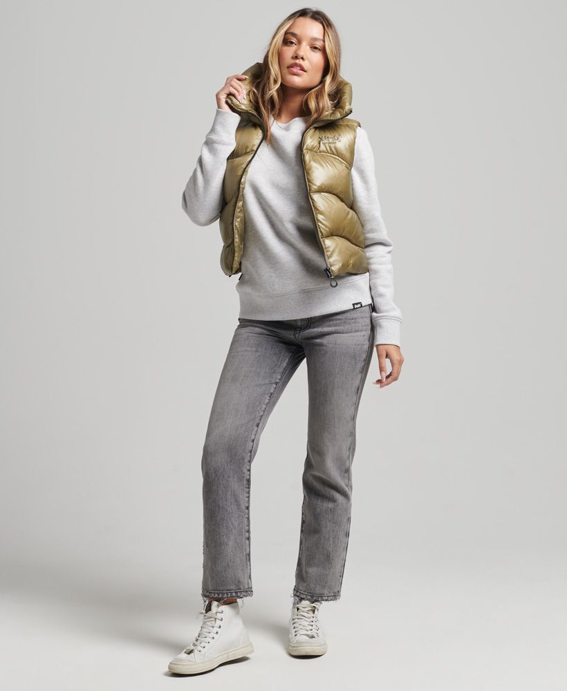 The Shine Quilt padded gilet brings a cropped chic to your layering options, helping you stay warm with a luxurious combination of soft lining and quilted padding. Thanks to its classic gilet design, it allows you to stay sporty and mobile with maximum ease of movement and its lightweight design, making it an excellent choice as a go-to layer for a combination of both function and cosy style.Padded designHood with drawcord adjustmentZip fasteningEmbroidered detailing on chestTwo zip-fastened side pocketsBungee cord adjustable hemFully linedThe padding in this jacket is 100% recycled, each jacket contains up to 20 recycled bottles, this avoids these bottles being sent to landfill or polluting our oceans.