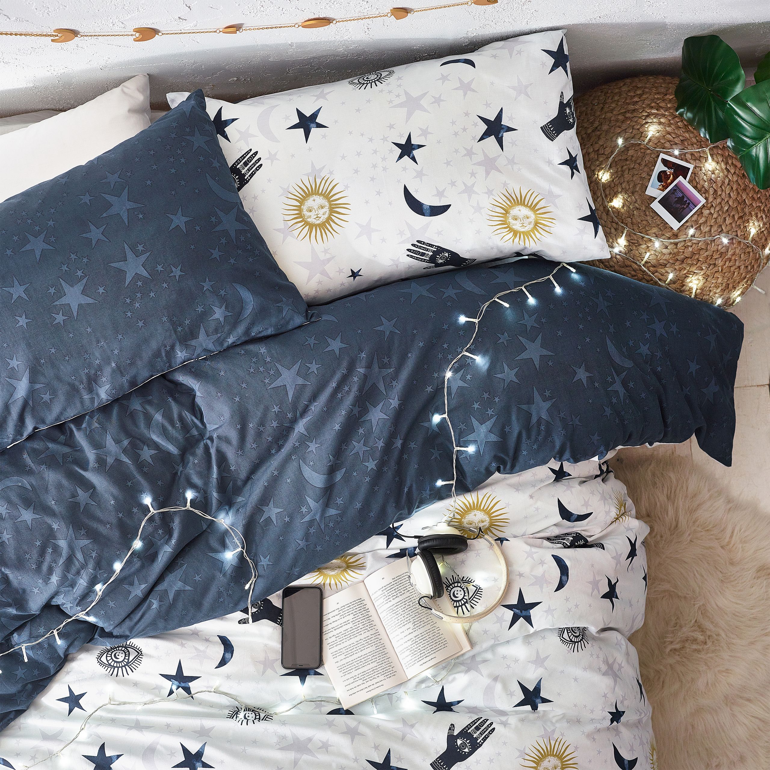 Make your bedroom mystical with this Stargazer duvet set. Featuring a galaxy of suns, moons and stars surrounded by mystical eyes and zodiacs constellations. The magic continues to the reverse with a complimenting design of twinkling stars on a darker base so you can switch the look when you need to.