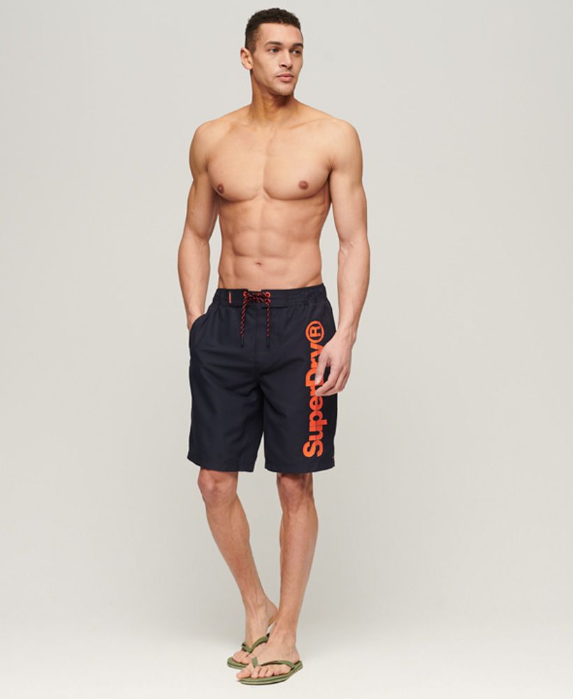 Bring that sporty edge to your look with our Classic Boardshorts. Designed to bring you an iconic look even when you're hitting the water, these swim shorts are a comfortable option. Finished with bold branding to bring the look together.Waistband with elasticated sidesHook and loop fastening waistLace tieTwin side pocketsSilicone print logo on the legBack zip pocketsMesh liningSilicone Superdry tab and patch