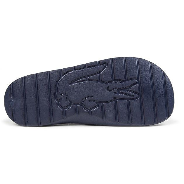Step into on trend summer style with these mensCroco Slides from Lacoste. In a bang on trend colourway, these designer sandals are delivered in a smooth synthetic upper with Croc detailing across the forefoot foot strap. The one piece upper delivers a super comfy footbed which moulds to your feet delivering the perfect fit and feel while the grippy outsole will keep you sure and safe around the pool or in the shower. These designer slides are finished with eye catching Lacoste branding throughout just in case you want a sign of approval that youre wearing cool on trend style this summer season 
 - One piece synthetic upper
 - Comfort moulded footbed
 - Grippy outsole
 - Slip on wear
 - Iconic Lacoste branding throughout
 Please Note: These slides are supplied poly bagged (without box)
 These Lacoste Slides are sold as B grades which means there may be some very slight cosmetic issues on the shoe and they come in a poly bag. There could be occasional issues with wrong swing tags being allocated to wrong shoes by Lacoste themselves which could result in some size confusion but you must take the size IN THE SHOE as the size that the shoe actually is ( not what is on the tag ). We have checked most of the shoes and in our opinion,all are practically perfect without any blemishes on them at all and in essence if the shoes did not have the letter B denoted on the swing tag you would presume these were perfect shoes. All shoes are guaranteed against fair wear and tear and offer a substantial saving against the normal high street price. The overall function or performance of the shoe will not be affected by any minor cosmetic issues. B Grades are original authentic products released by the brand manufacturer with their approval at greatly reduced prices. If you are unhappy with your purchase, we will be more than happy to take the shoes back from you and issue a full refund