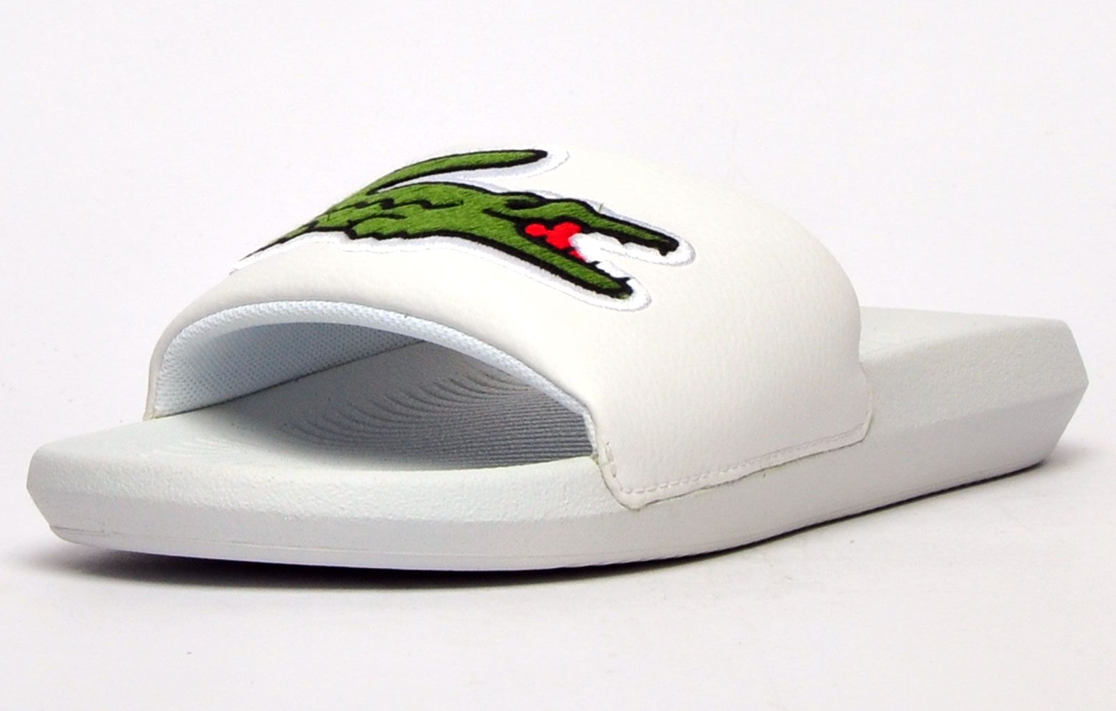 Step into eye catching summer style with these mens Croco Slides from Lacoste. In a bang on trend colourway, these designer sandals are delivered in a smooth synthetic upper with croc detailing across the forefoot foot strap. The comfy footbed moulds to your feet, delivering the perfect fit and feel while the grippy outsole will keep you sure and safe around the pool or in the shower. These designer slides are finished with eye catching Lacoste branding throughout just in case you want a sign of approval that youre wearing cool classic style this summer season 
 - Comfort moulded footbed
 - Single strap detail over foot
 - Grippy outsole
 - Slip on wear
 - Iconic Lacoste branding throughout
 Please Note: These Lacoste Sliders are sold as B grades which means they have some slight cosmetic issues on the shoe and they come poly bagged. All shoes are guaranteed against fair wear and tear and offer a substantial saving against the normal high street price. The overall function or performance of the shoe will not be affected by cosmetic issues. B Grades are original authentic products released by the brand manufacturer with their approval at greatly reduced prices. If you are unhappy with your purchase we will be more than happy to take the shoes back from you and issue a full refund.