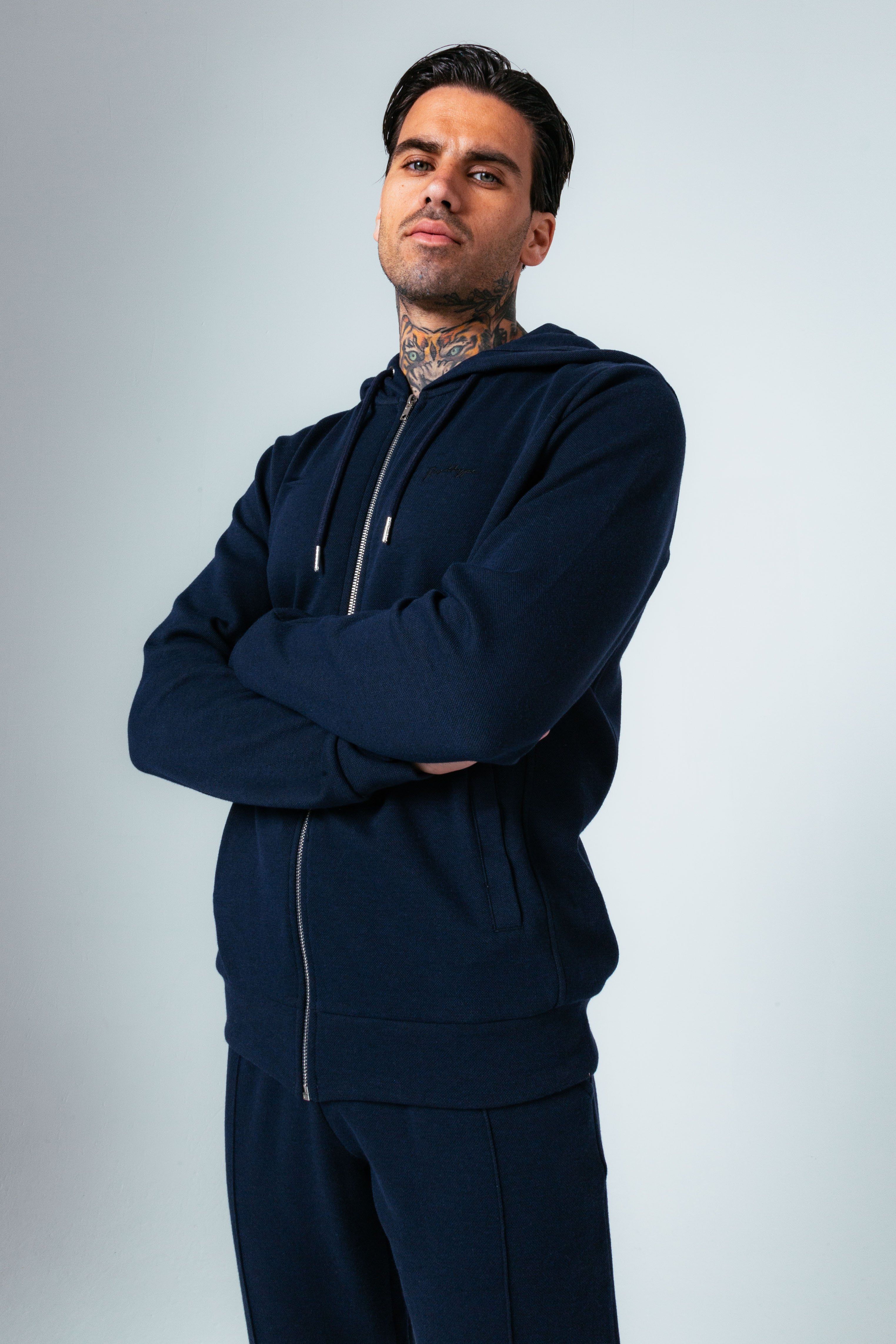 The HYPE. Navy Pique Oversized Men's Pullover Hoodie is your new go-to everyday essential. Designed in our standard men's jacket shape, with a fixed hood, double pocket sand fitted hem and cuffs. With a 50% cotton and 50% polyester fabric base for supreme comfort and breathable space. With a dark navy colour palette, high neck detail and 5 thread cover stitch. Finished with the new! embroidered just hype signature logo embroidered on the front. Wear with the matching joggers for a smart casual look. Machine washable.
