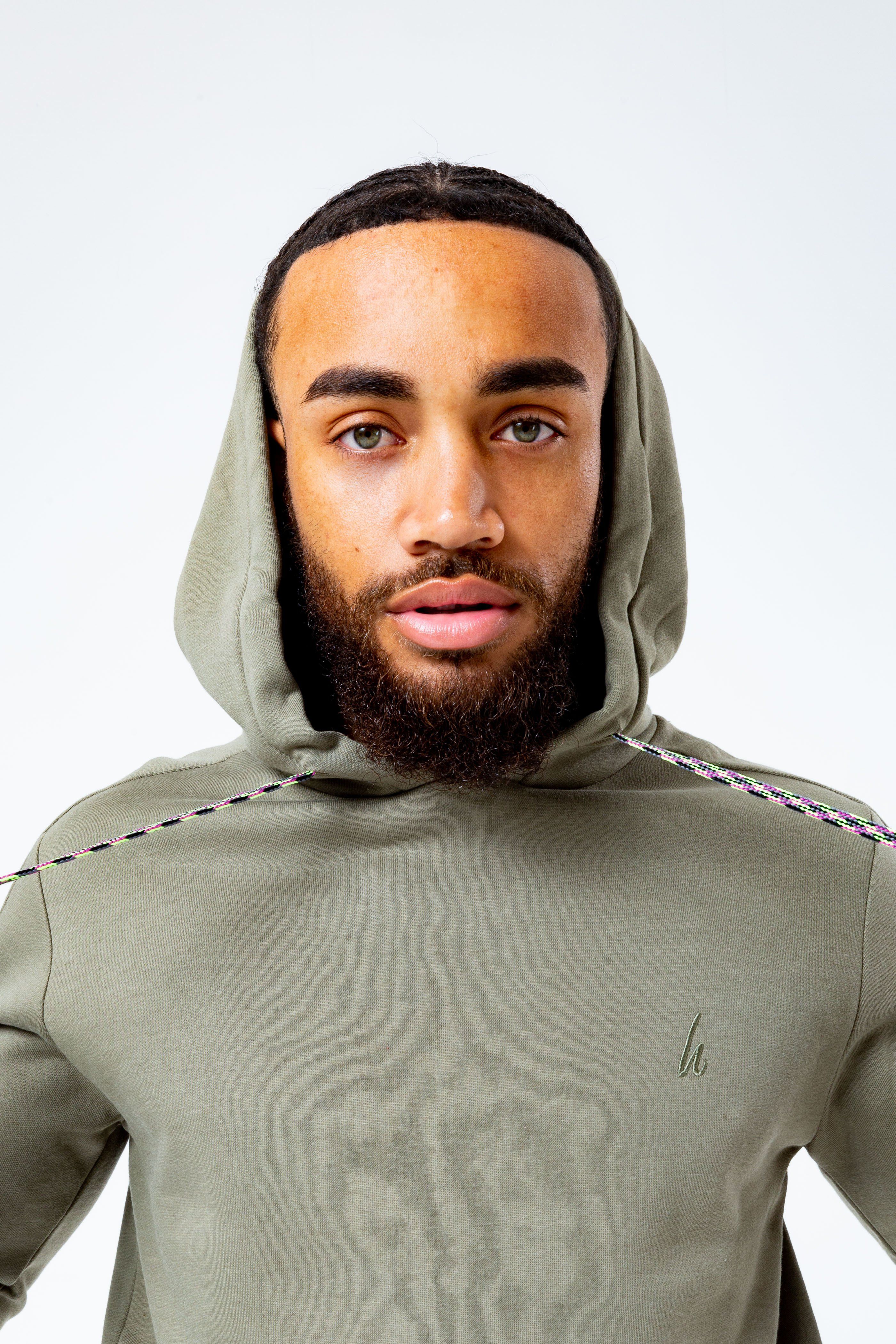 The HYPE. Olive Oversized Men's Pullover Hoodie is your new go-to everyday essential. Designed in our oversized men's hoodie shape, with a fixed hood, kangaroo pocket and fitted hem and cuffs. With a 80% cotton and 20% polyester fabric base for supreme comfort and breathable space. With a olive khaki colour palette, self fabric piping and extra long on-trend paracord strings. Finished with the new! embroidered just hype signature logo embroidered on the front. Wear with black skinny fit jeans for a smart casual look. Machine washable.