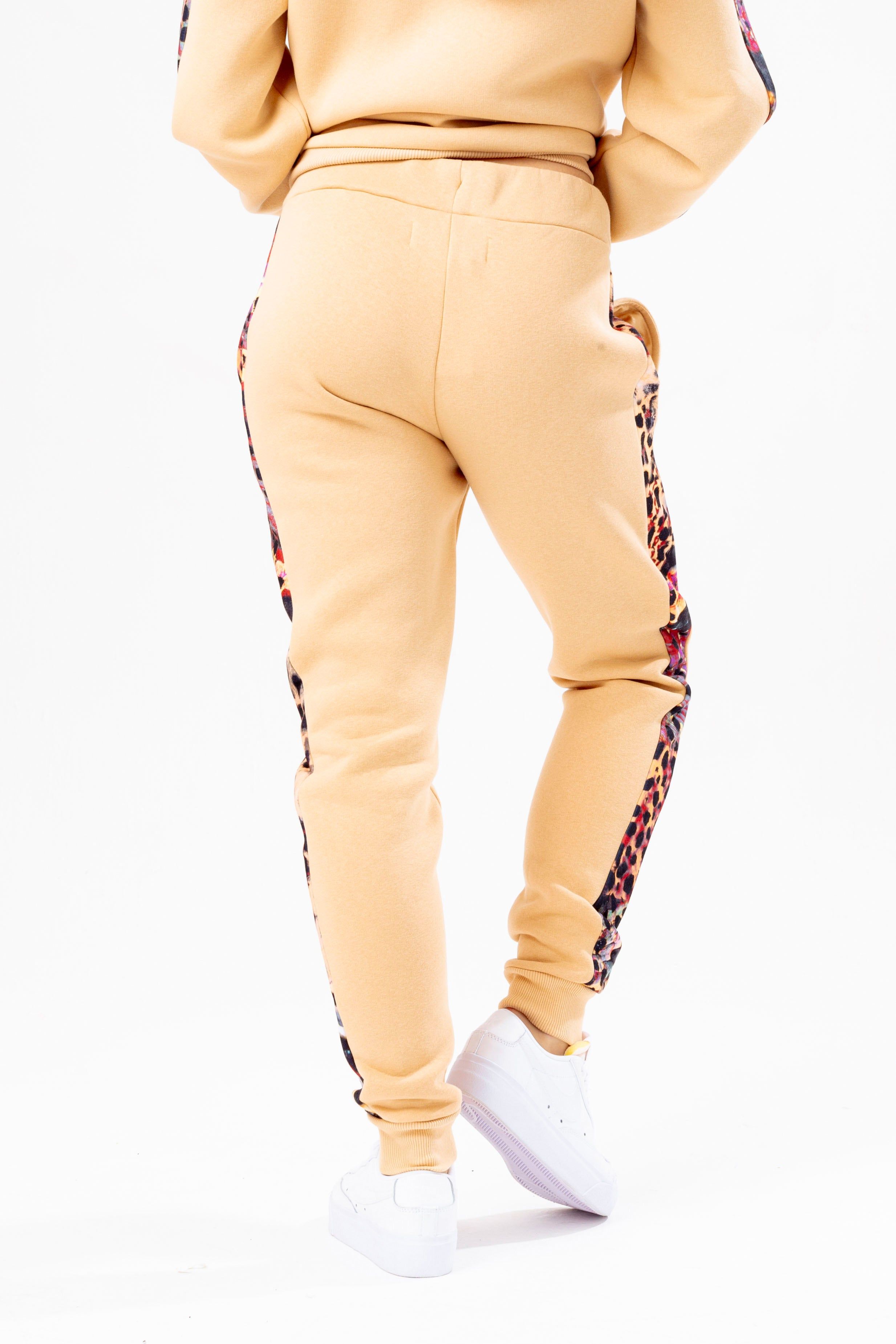 Meet the HYPE. Women’s Hazelnut Animal Print Label Joggers. Made from an 80% cotton 20% poly fabric blend in hazelnut for ultimate comfort. Featuring screen printed drawstrings and sublimated animal print panels, these joggers are the perfect addition to your jogger 'drobe. Wear with the matching HYPE. Hazelnut Animal Print Label Hoodie and T-Shirt for a comfortable, off-duty look.