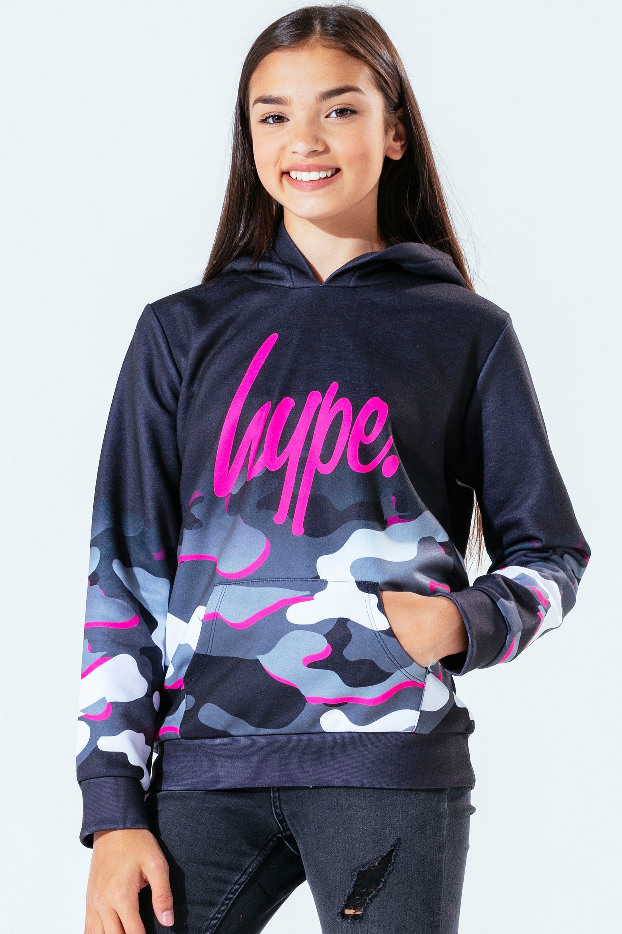 The Hype. pink line camo girls hoodie features our signature camo print in a monochrome, grey and pink injection colour palette. In a 95% polyester and 5% cotton fabric base for supreme comfort in our standard kids pullover shape, highlighting a fixed hood, kangaroo pocket and fitted hem and cuffs. Finished with the iconic HYPE. script logo in a holographic fabric. Wear with cycle shorts for an on-trend look. Machine wash at 30 degrees.