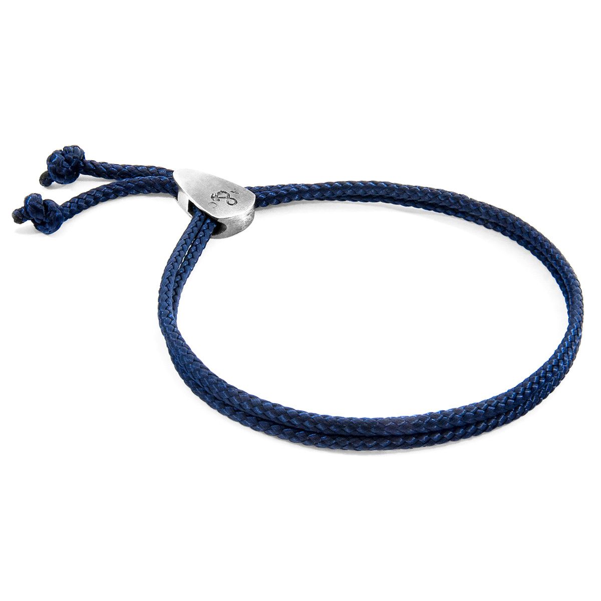 The Navy Blue Pembroke Silver and Rope Bracelet was both designed and skilfully handcrafted completely in Great Britain, In Quality We Trust. For the Modern Journeyman (and woman), ANCHOR & CREW takes ownership of an exploratory lifestyle and enjoys the Happy-Good Life. Combining British craft manufacturing with a discerning modern-minimalist style, this ANCHOR & CREW bracelet features: 

3mm diameter performance Marine Grade polyester and nylon rope (GB)
Solid .925 sterling silver divider pulley (GB) 

SIZING
This bracelet is one size fits all, with the rope able to extend or tighten to suit your wrist size. To take the bracelet on or off your wrist, simply push or pull the dividing slider along the rope to make the wrist-gap smaller or larger.