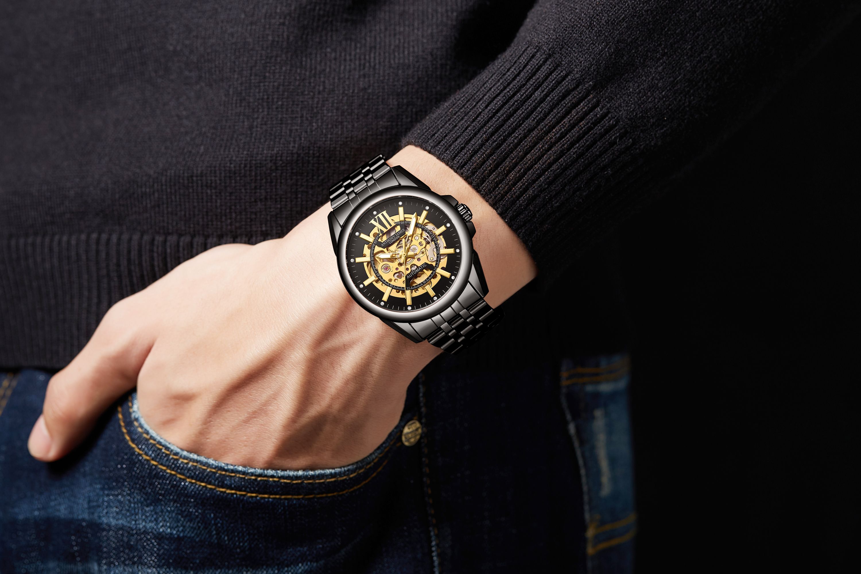 The Hand Assembled Anthony James Limited Edition Mystique Automatic Black men’s watch boasts 162 part 21 jewel movement and exhibits superb accuracy that is enhanced by the gold skeletonised dial, contrasting boldly against the black border, and this same engineering is viewable from the caseback. It is water resistant to 3ATM, while the scratch resistant mineral glass is both sophisticated and reliable. The raven black IP stainless steel bracelet secures the timepiece, which comes complete with a five-year warranty.

Watch Specification
• Automatic Movement
• Hand Assembled 162 Part 21 Jewel Movement
• Black with Gold Skeletonised Dial 
• Water Resistant 3ATM
• Scratch Resistant Mineral Glass
• 5 Year Warranty

Sizes & Weights
• Case Diameter 42 mm 
• Case Thickness 14 mm
• Lug Width 22 mm
• Strap Width 20 mm
• Strap Length 220 mm
• Weight 123 Grams

Materials & Colour
• Steel & Alloy Case 
• Skeleton Caseback
• Black IP Stainless Steel Bracelet  
• Folding Safety Clasp with Logo
• Logo Crown