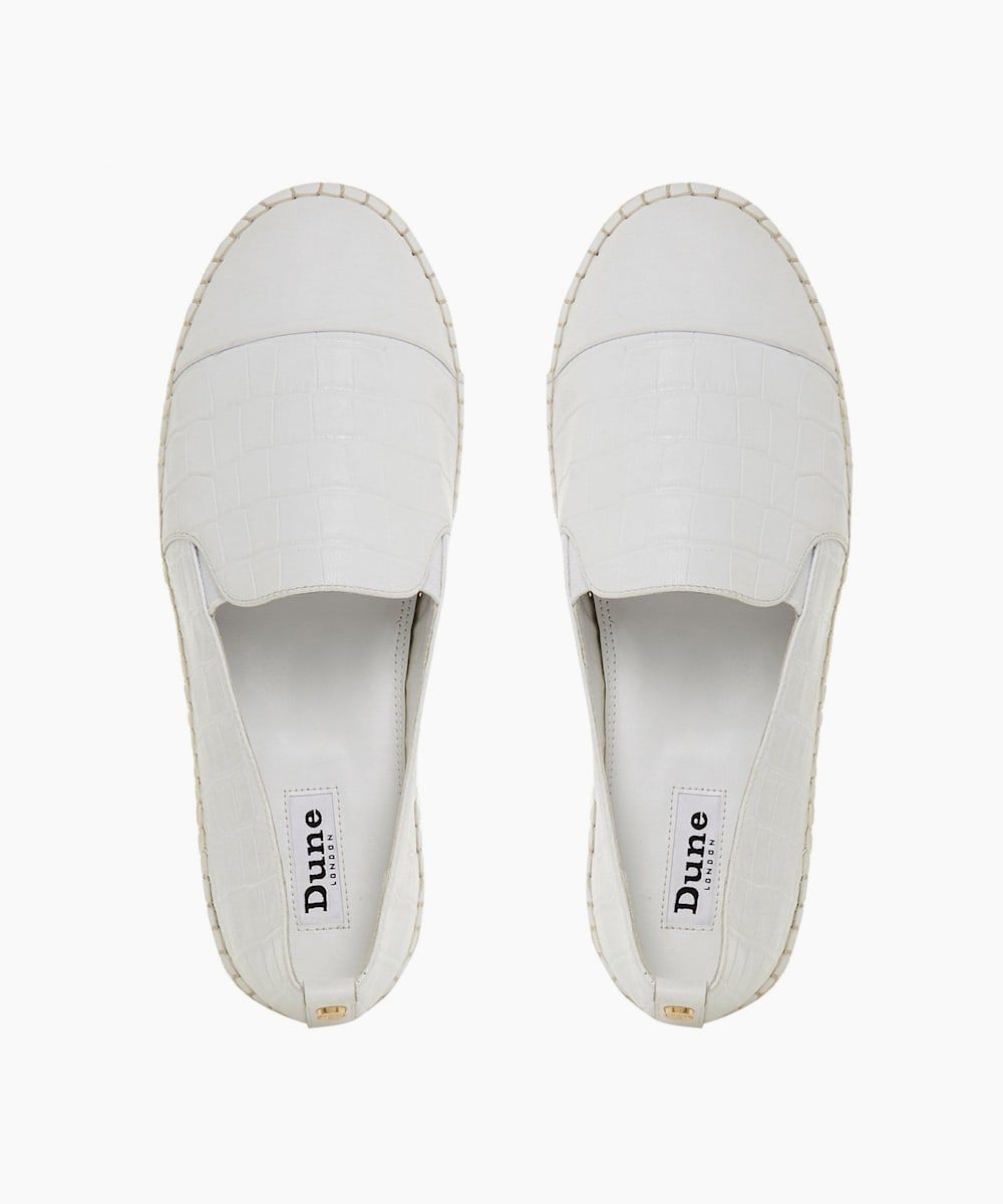 Elevate your everyday style with the Glympse shoe from Dune London. Showcasing a mini wedge espadrille sole, it has a toe cap detail. A pull up tab and slipper cut silhouette complete the design.