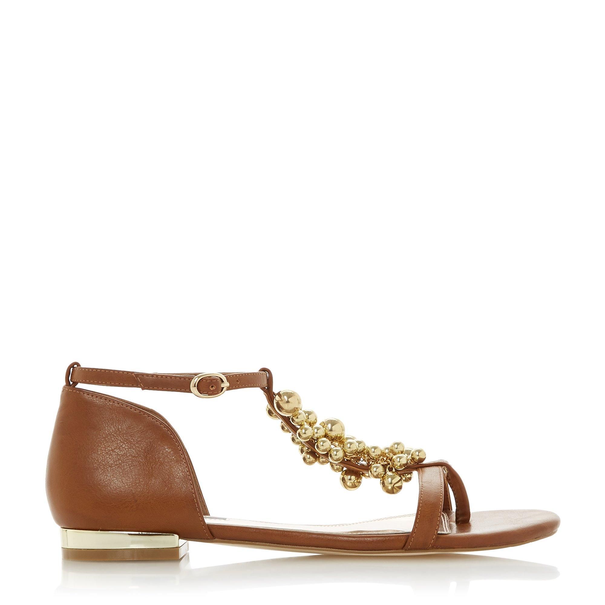 Make a summer style statement with the Dune London Hobart 2 sandal. Showcasing stylish gold-toned ball embellishments on the T-Bar strap. It's complete with a metal trim on the heel and a secure buckle fastening.