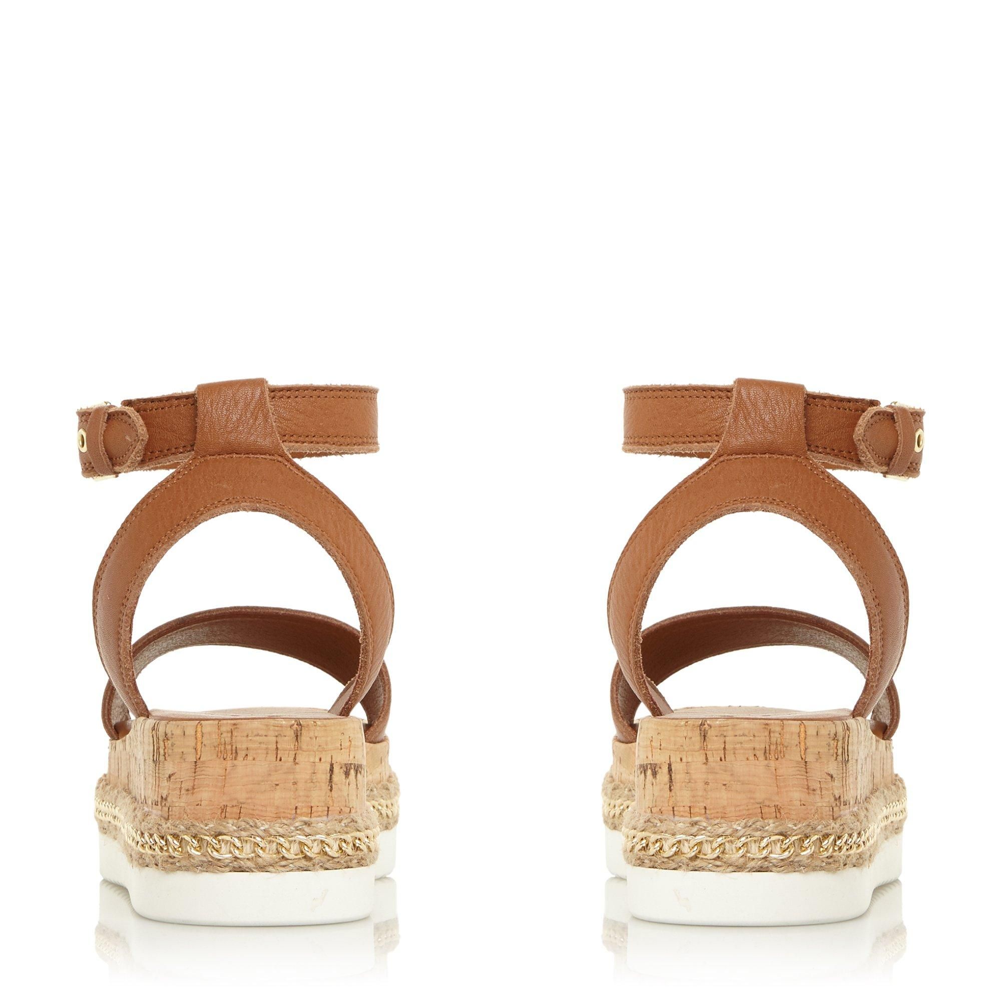 Refresh your summertime styling with the Krest sandal. It's raised on a medium cork wedge. Complete with an open toe and secure buckle-fastened ankle strap.