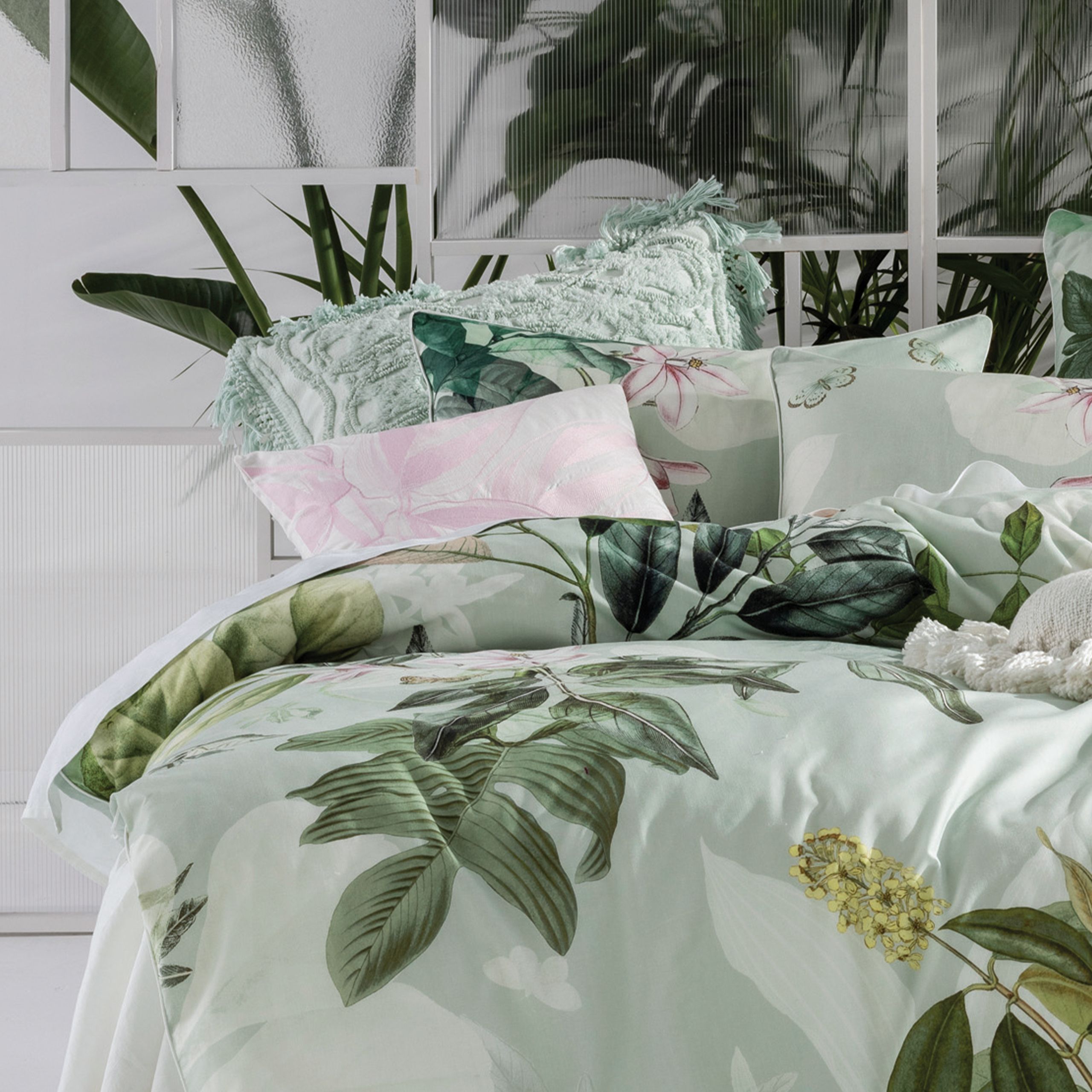 Bring your bedroomto life with Glasshouse, a mint-hued and contemporary collage of lush, tropical botanicals. Digitally printed on a luxurious cotton slub, this duvet cover set is trimmed with white cord piping. The archival-styled design looks best when adorned with its coordinating European pillowcases and colour-popping pink cushion.
