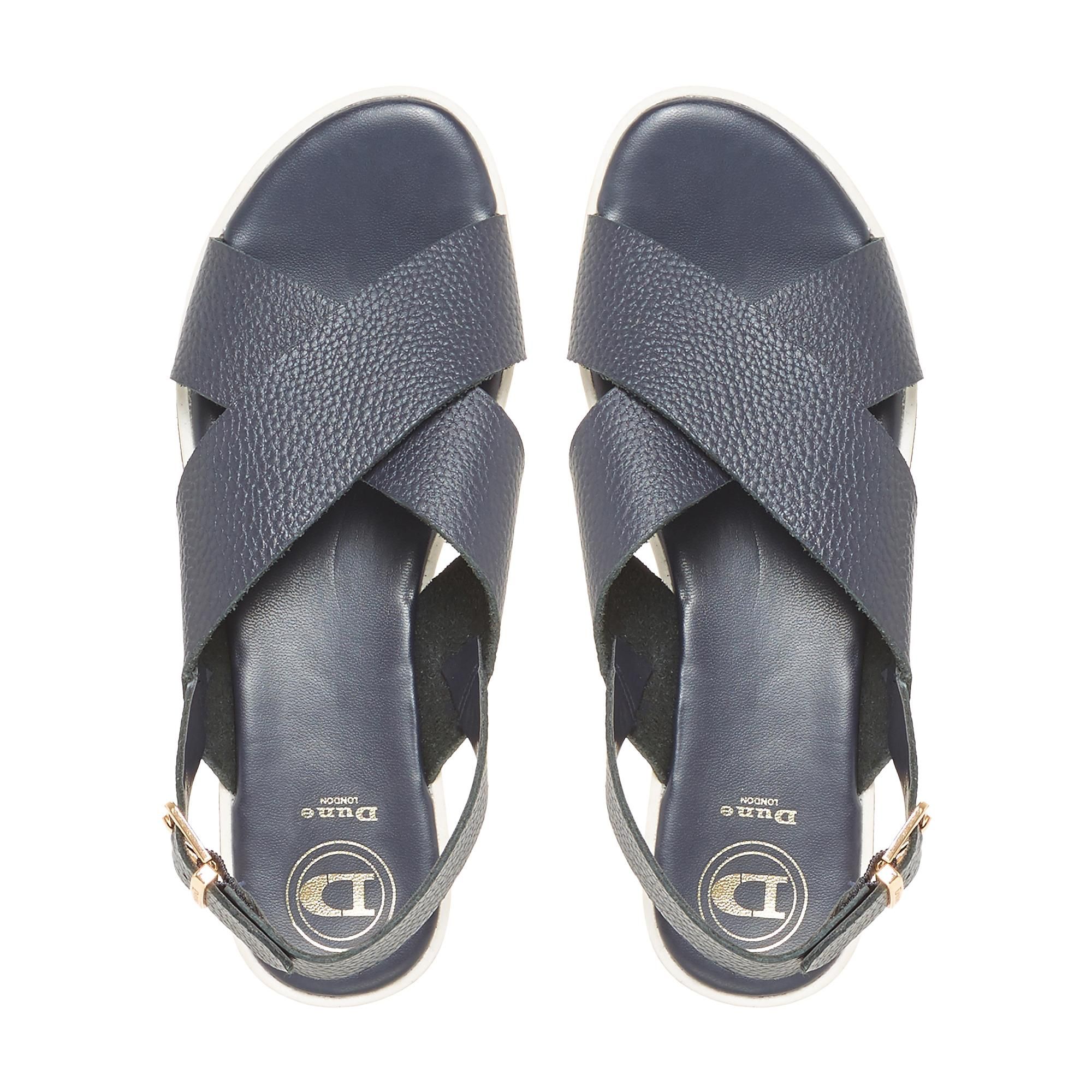 Channel casual elegance with this fetching Dune London sandal. Designed with stylish cross straps and a buckle fastening at the ankle. A flat cork heel and shark sole complete this summer style.