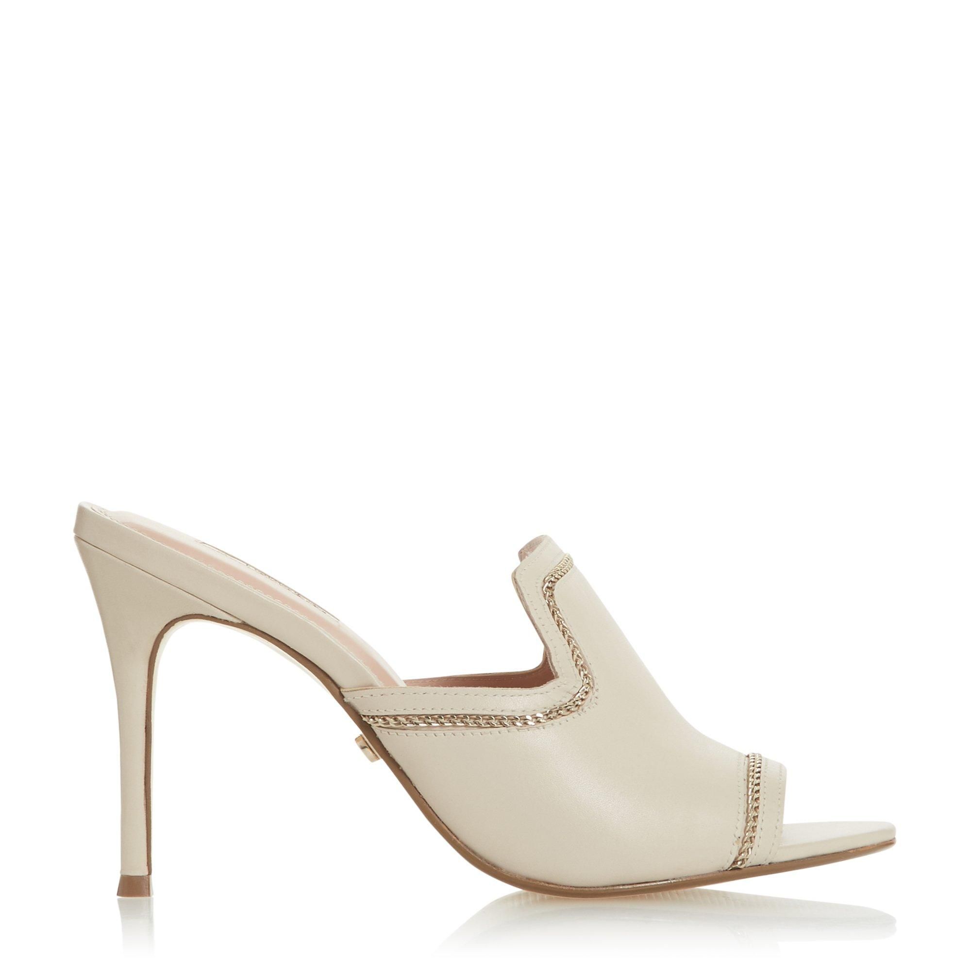 Add a dose of contemporary style to your line-up with this mule sandal. Offsetting a minimalist base with hardware, it sits on a stiletto heel. It's complete with a modern cut-out design on the sides.