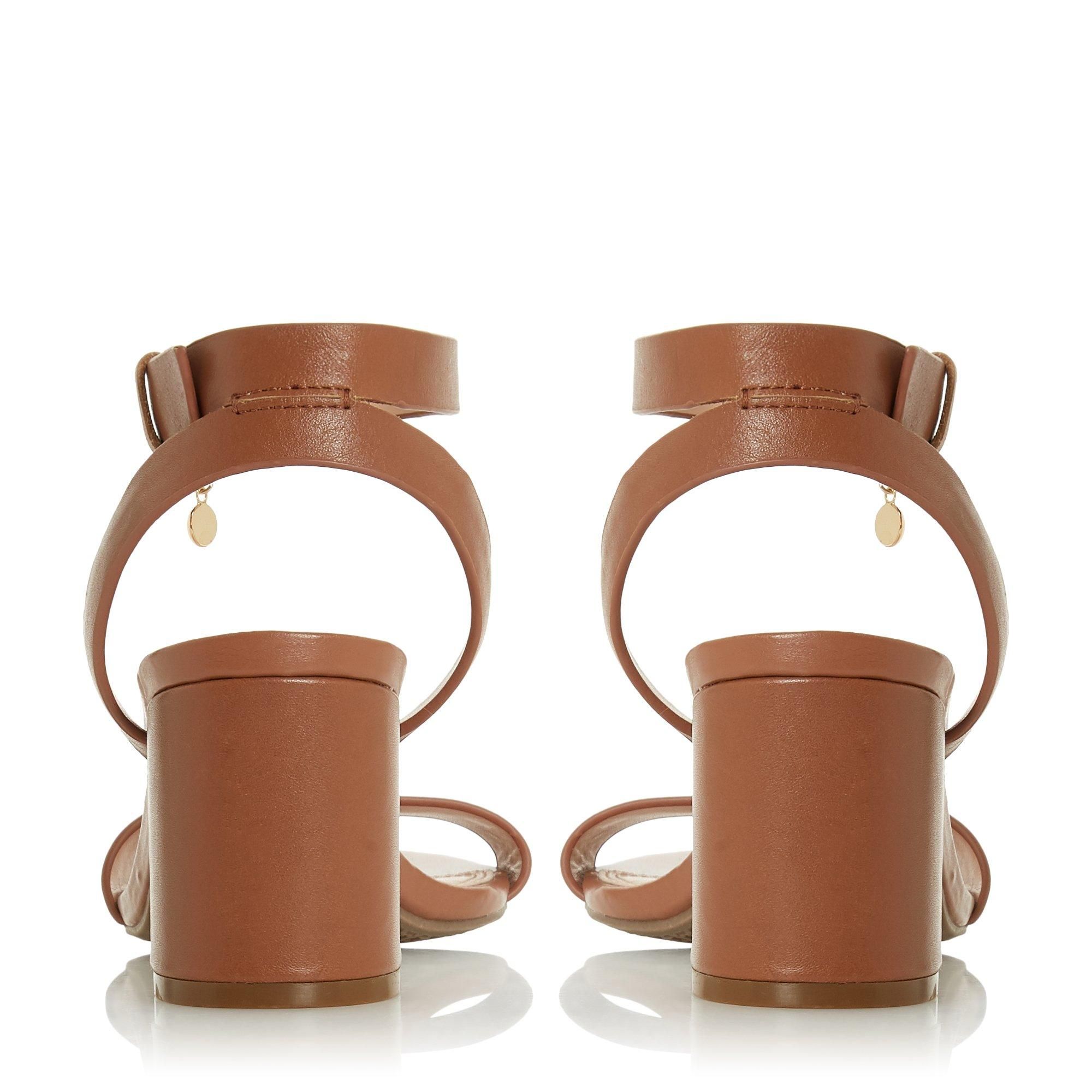 Embolden your favourite edits with this chic sandal. Fitted with a slender buckled ankle strap with a delicate chain. It rests on a contrasting mid block heel.