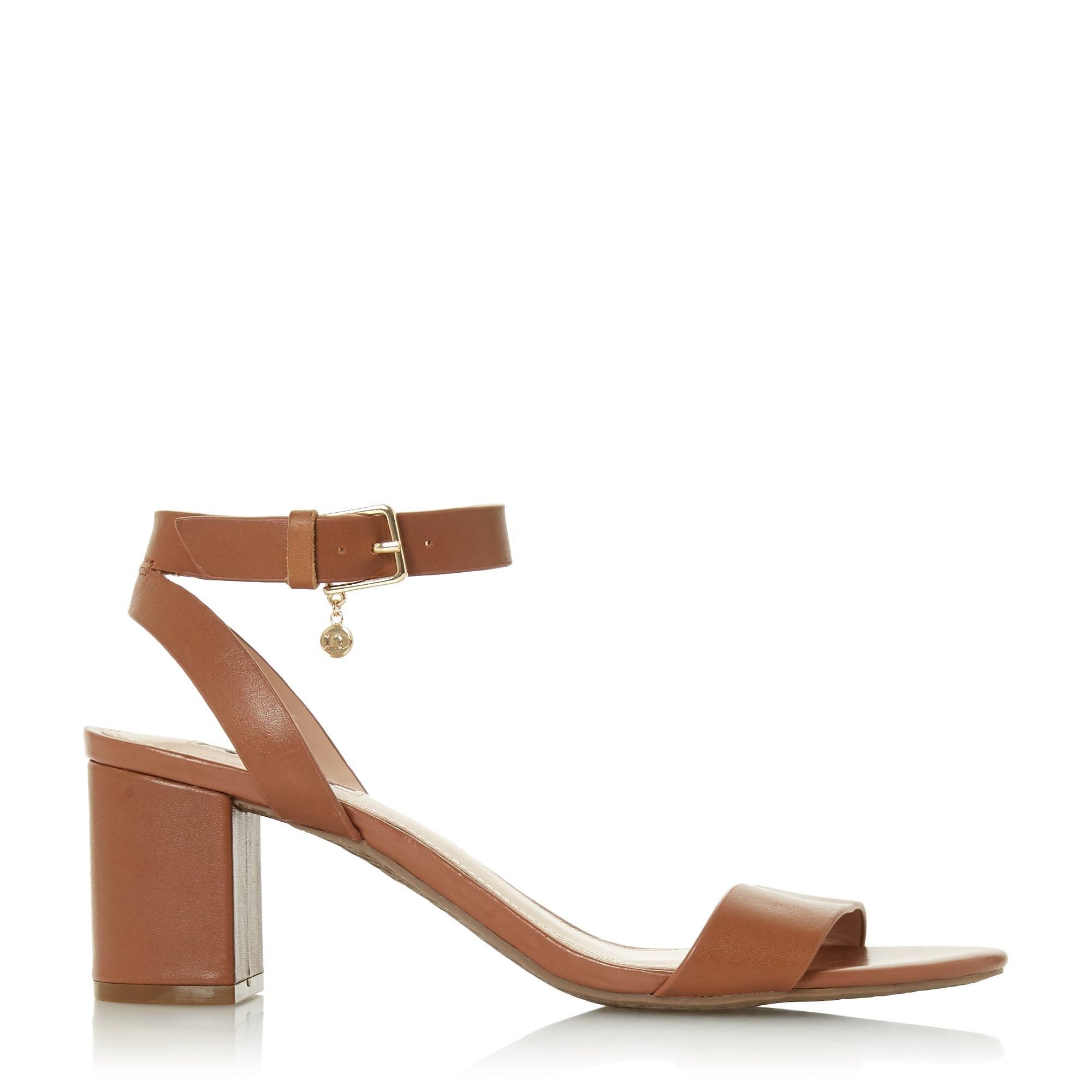 Embolden your favourite edits with this chic sandal. Fitted with a slender buckled ankle strap with a delicate chain. It rests on a contrasting mid block heel.