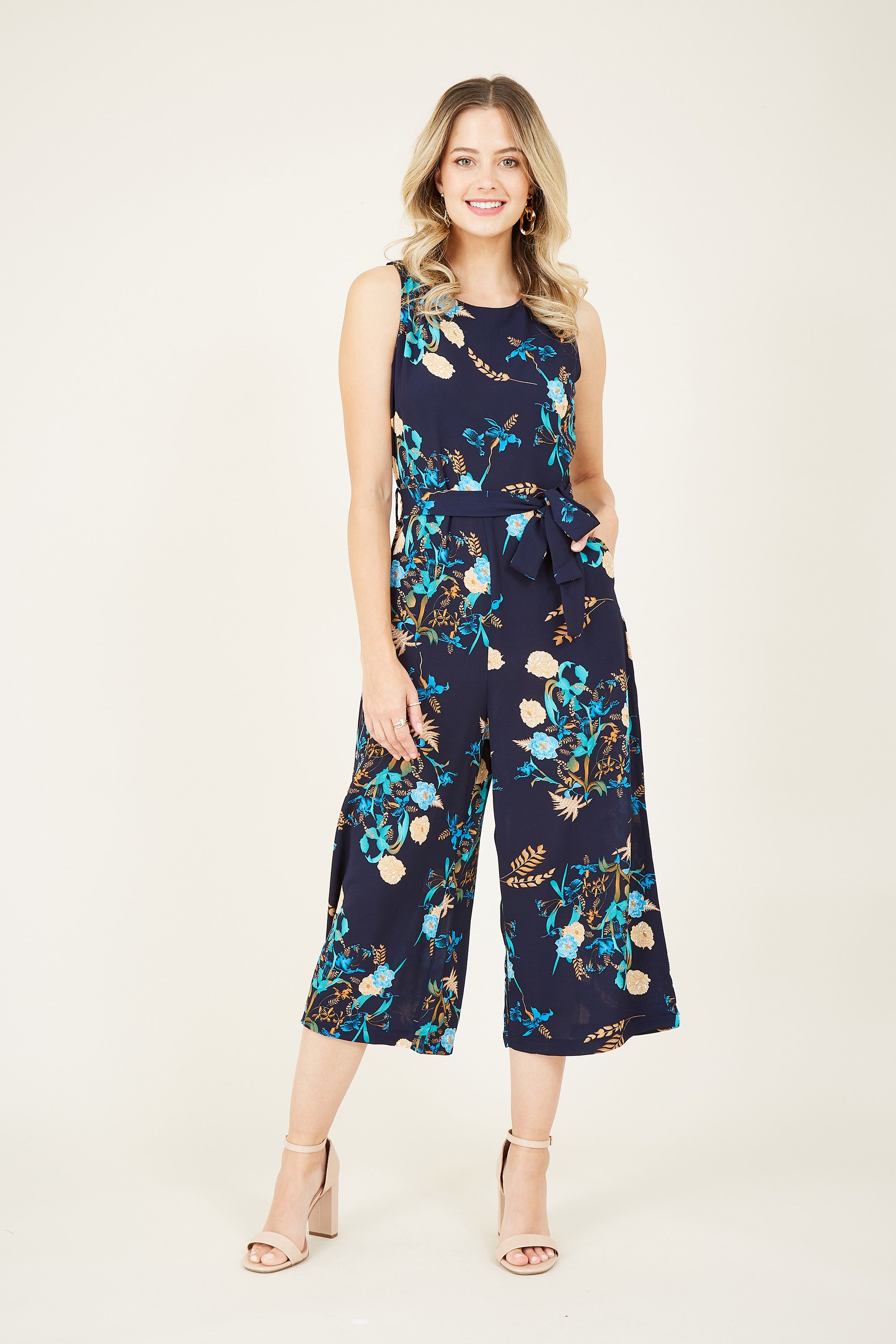In a pretty floral print, our Mela Garden Floral Jumpsuit is cut in a classic floaty shape. The light fabric and culotte trousers offer a breathable edge to your look, with a self-tie waist designed to enhance your curves. Pockets add a casual feel, with a zip fastening on the back to finish.