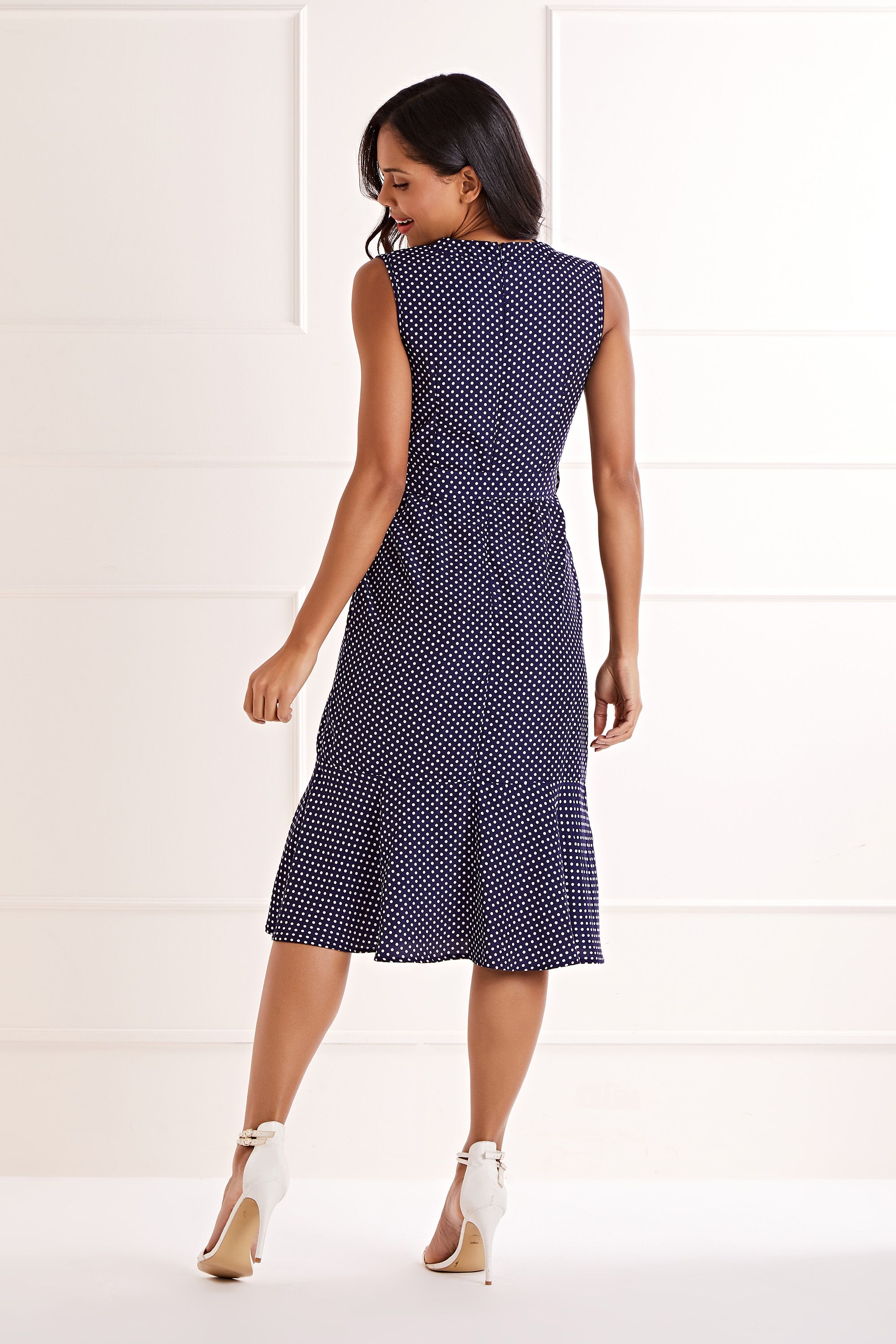 Hit the spot every time with our Polka Dot Wrap Front Midi Dress. In the classic sleeveless shape that you adore, it’s styled in a wrap shape that ties at the waist. Ruffles and polka-dots run through the lightweight fabric, making it a stylish and comfortable choice for work and weekends. Bring your outfit to life with red heels.