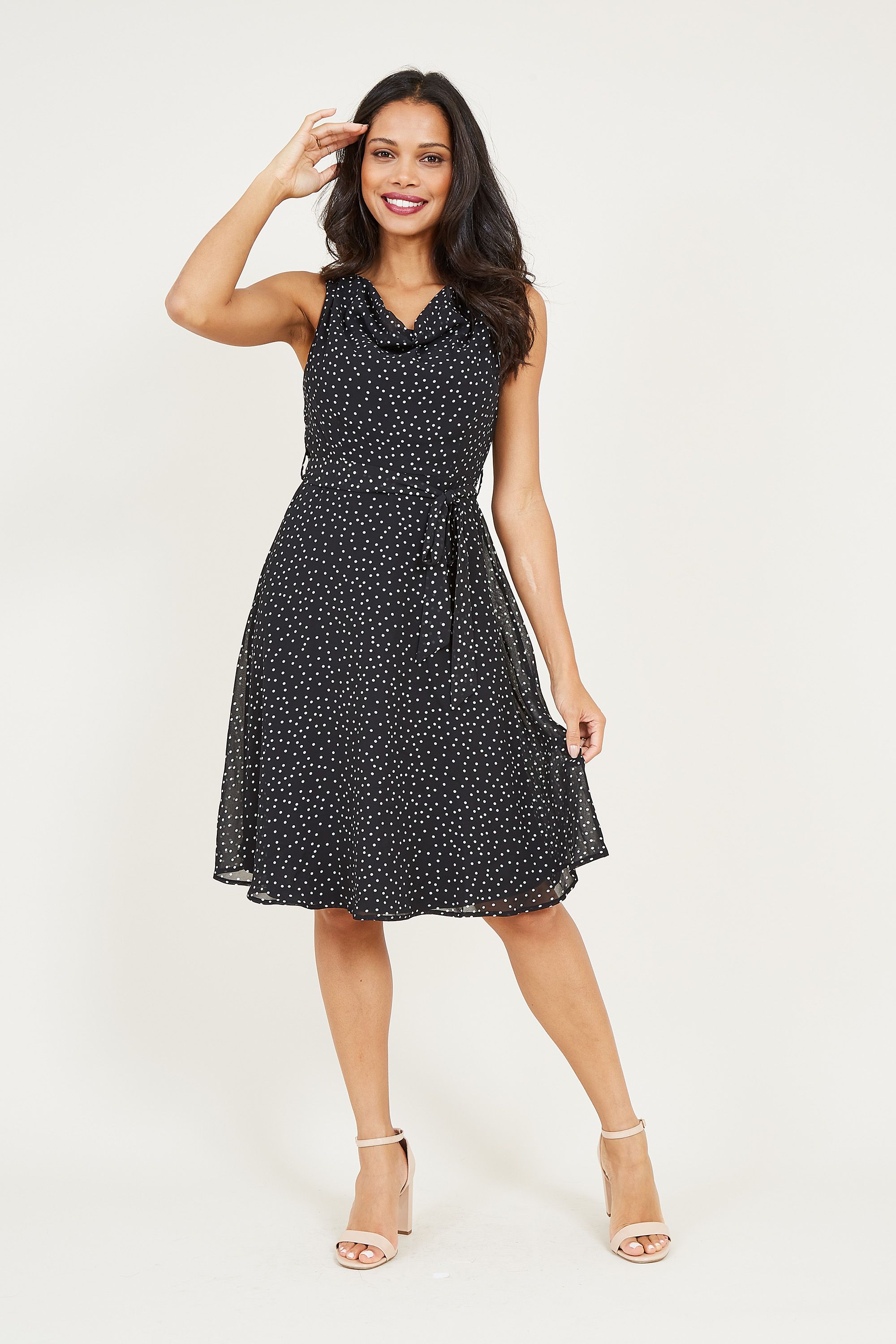 Exude total sophistication with our Mela Polka Dot Skater Dress. Featuring a classic fit and flare shape, it's made from lighweight fabric that drapes over the knee. With a tie waist to adjust to your profile, it's enhanced by a cowl neckline for a voluminous finish. Wear with heels to work or dress it down on weekends.