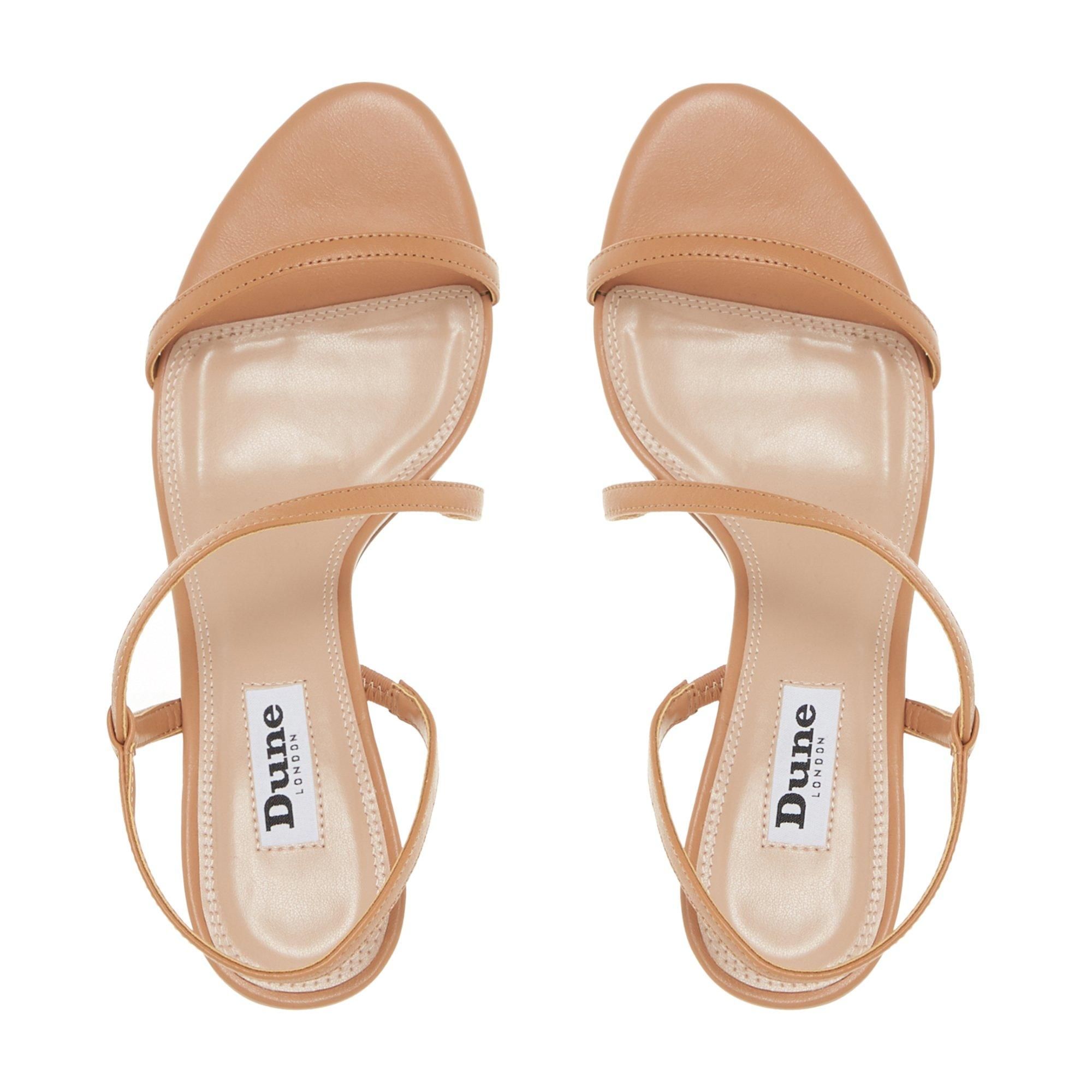 This sandal by Dune London is a simple yet stylish evening option. Showcasing a feminine asymmetric strap with a slingback design. It features an open sandal toe and rests on a mid stiletto heel.