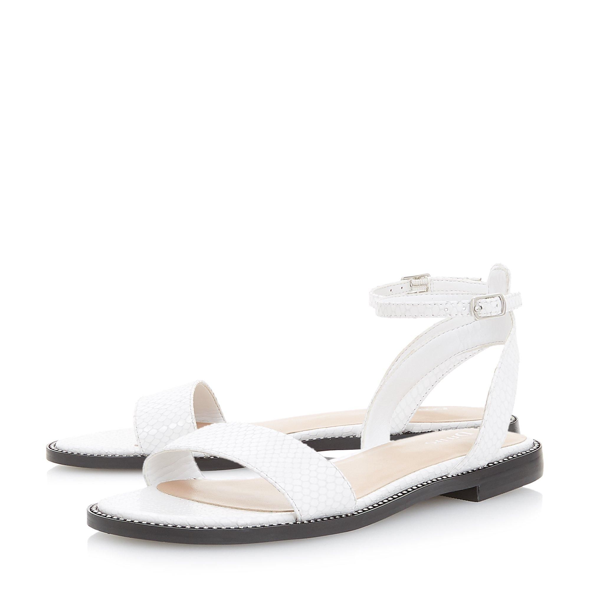 The Dune London Nance two part sandal is a chic summertime style. Featuring a textured slim front strap, an open back and ankle strap. It's perched on a low block heel with an understated studded trim.