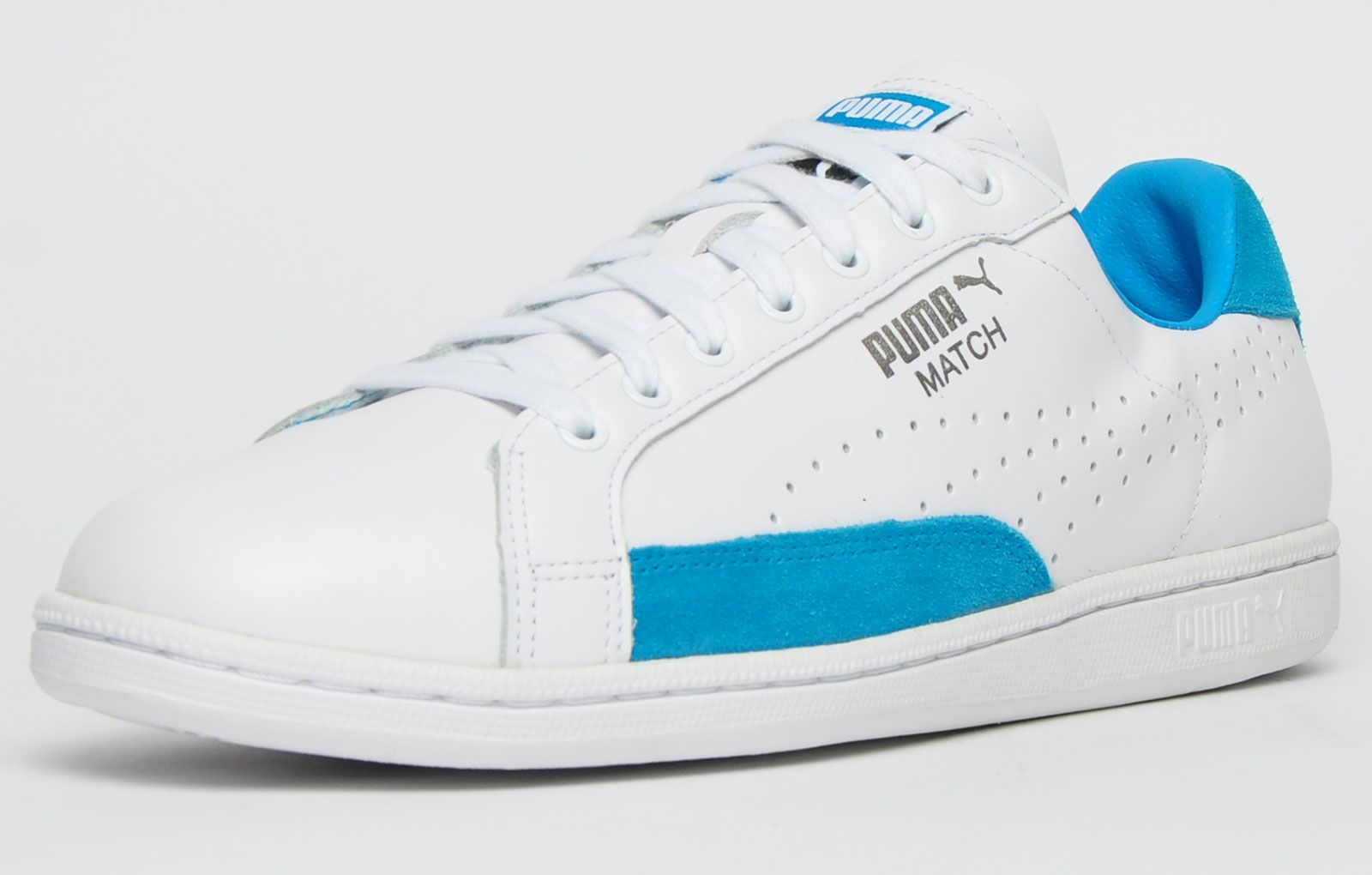 The Puma Match 74 UPC from the iconic 1974 tennis collection features a soft leather upper with side perforations for breathability with the addition of suede panelling to the sides and heel with silver Puma branding to the side to complete the look. <p>The Match 74 men’s shoe is finished off with a durable rubber sole with a textured vintage styled finish which will provide stability and grip on all surfaces and with a slimmed down look to give that sporty designer feel</p> <p class=