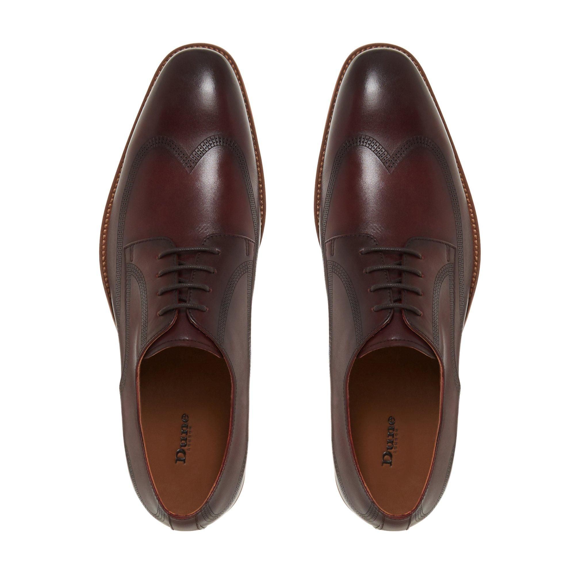 Update your formal looks with this dapper gibson shoe from Dune London. Showcasing a classic wingtip design with subtle topstitching. It's finished with a round toe, a low block heel and lace-up fastenings.