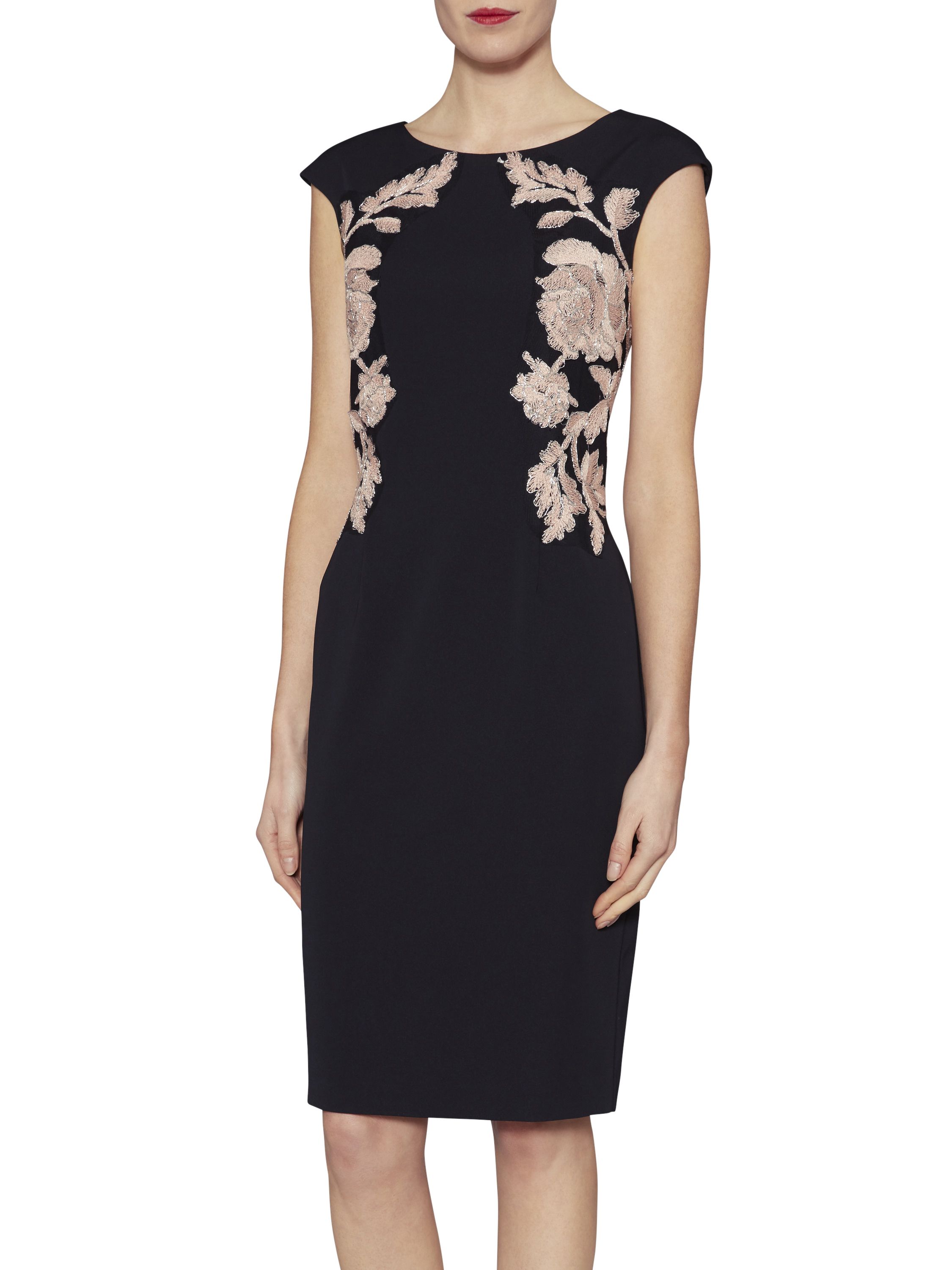 This elegant embroidered dress by Gina Bacconi will make you feel fabulous. Both sides of the dress have been embroidered with a beautiful symmetrical floral design. The dress is fully lined and fastens with a concealed back zip. It has back split for added class.