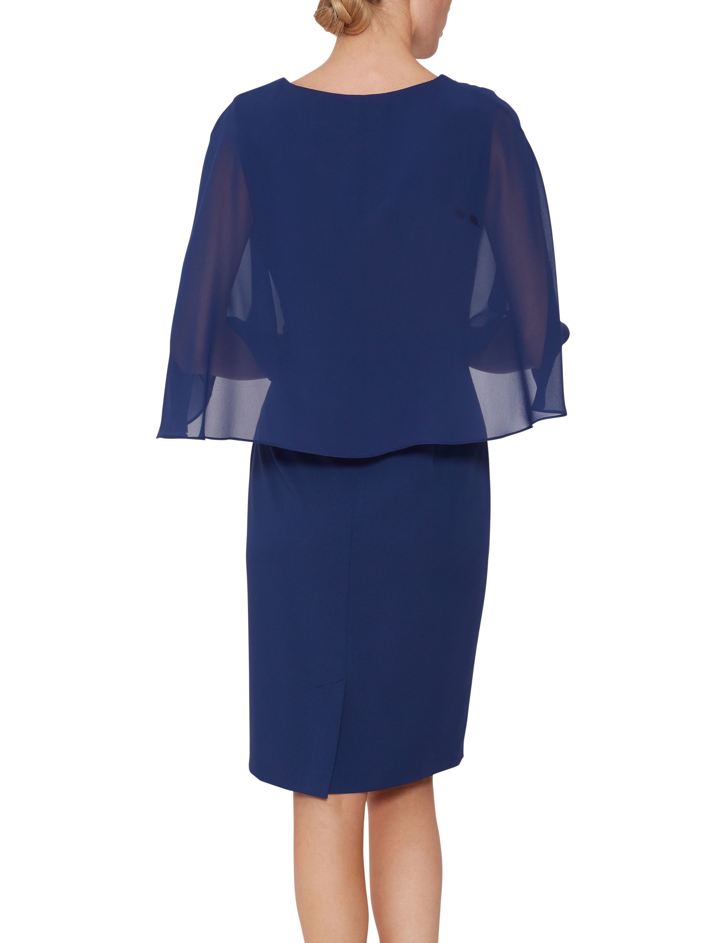 Make this stylish crepe dress and cape by Gina Bacconi one of your staple items this season. Fashioned from a gorgeous soft crepe fabric, the dress takes a simple shift shape to flatter the figure, accompanied by a cape attached at the neckline to cover the shoulders, featuring a guipure lace bodice underneath the cape for extra detailing. Fastened with a concealed side zip.