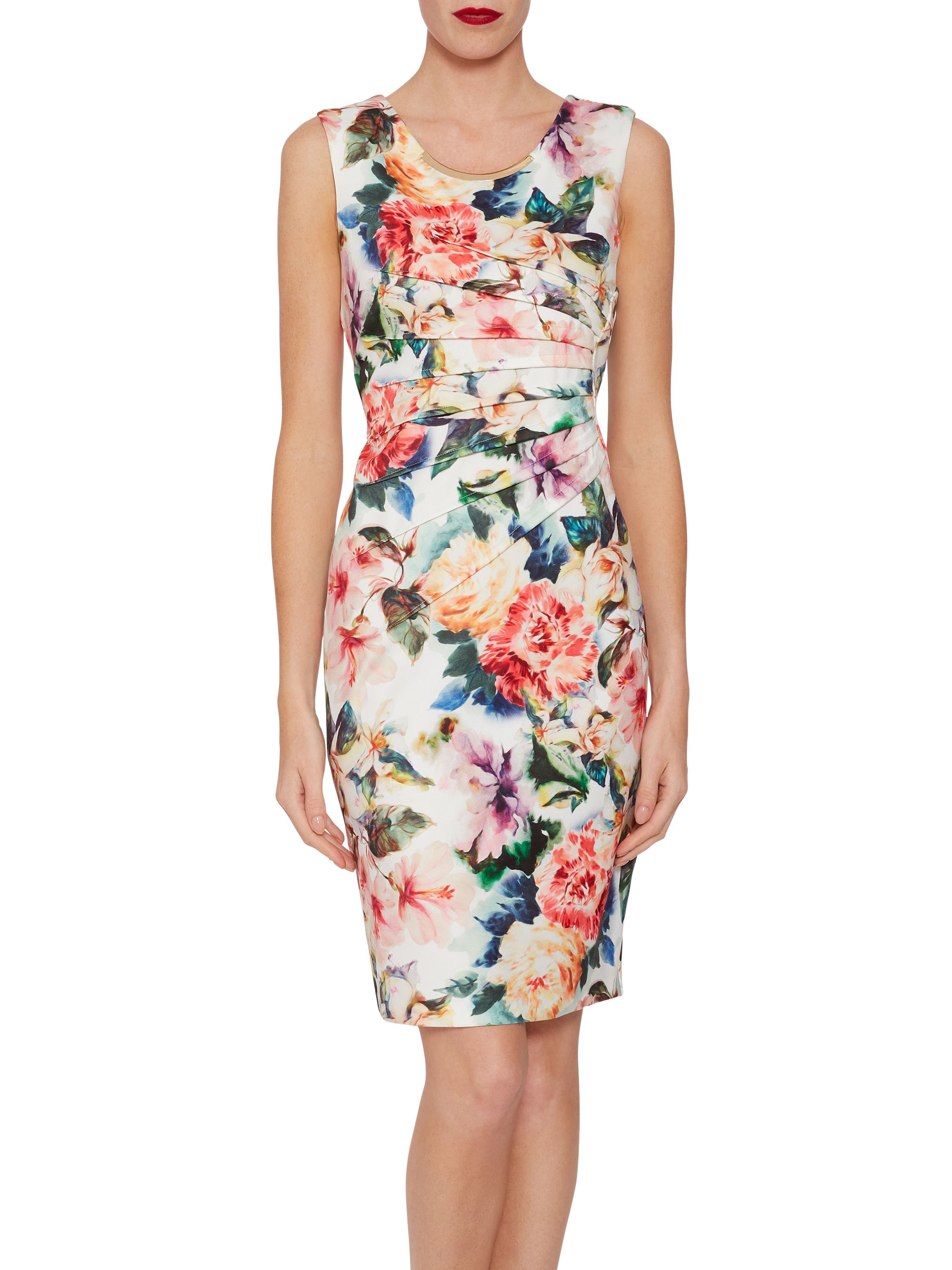 Feel elegant in this floral scuba dress by Gina Bacconi. Fashioned from a soft scuba stretch fabric, this piece offers both comfort and elegance. At the waist the dress features bold asymmetric design: darts radiate boldly from the side to flatter and give a modern edge to the dress. A gold insert at the neck makes for a glamorous finish. The dress fastens using a conealed back zip.