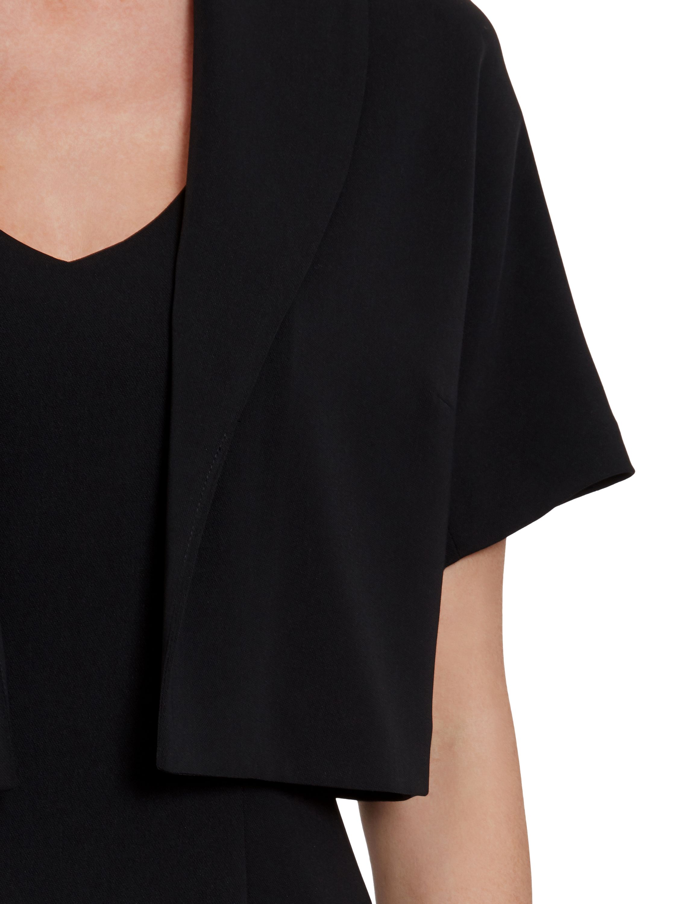 This fitted Gina Bacconi bolero is perfect over any outfit. The jacket is made up of a luxurious stretch moss crepe in a tailored style and features short sleeves and an elegant shawl collar to finish this piece off. This bolero comes in multiple colours.