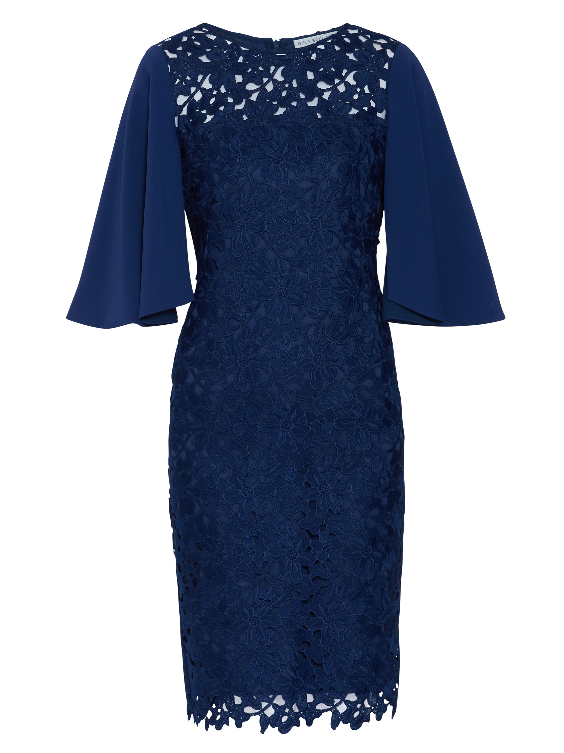 Made of luxurious guipure lace in a beautiful primrose design, this Gina Bacconi frock is simply perfect for the summer season. It is cut to flatter in a shift dress style, with an unlined sheer yoke and a round neckline.Featuring crepe cape sleeves for added class. The dress has a zip opening at the back as well as a hook and eye fastening which creates a keyhole shape feature.