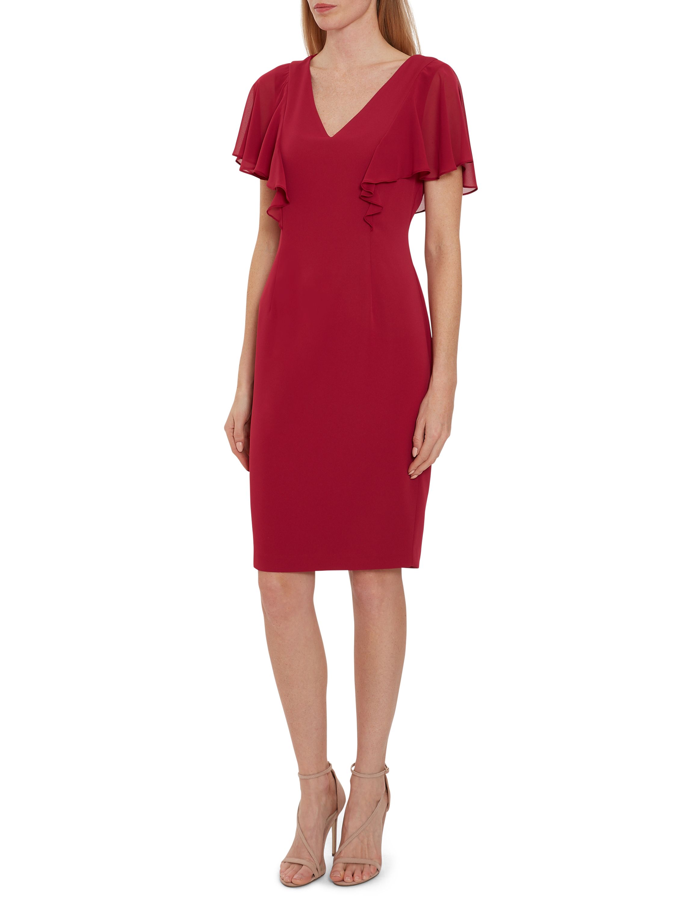 Add this frill dress by Gina Bacconi to your partywear wardrobe this season. This classic and versatile shift dress shape is fashioned from moss crepe. The dress is overlaid with elegant chiffon sleeves.The dress is lined and fastens with a zip and a button at the back of the neck.