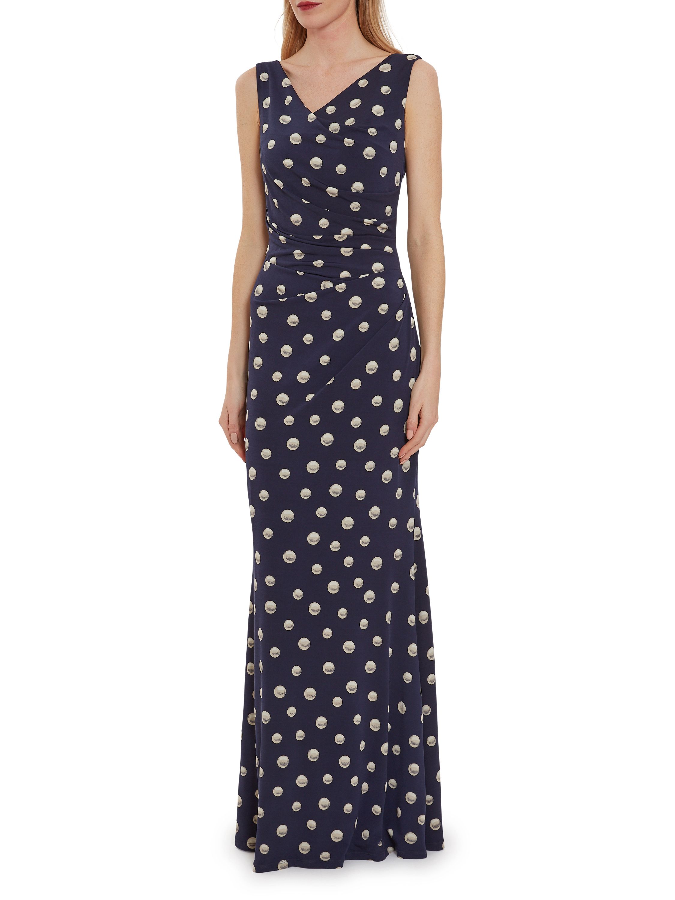 This maxi dress by Gina Bacconi is a showstopper of a piece. This piece is fashioned from a luxuriously soft pearl print jersey fabric which gracefully wraps over the bodice and ruches at the side of the waist. The asymmetric drape of the dress offers you a flawless silhouette. This dress is fully lined for extra comfort and fastens using a concealed centre back zip.